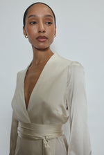 Bride wearing the ivory silk charmeuse Adelaide wrap gown, featuring a plunging neckline.