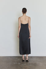 Back view of the black silk charmeuse Kamperett Agnes Slip Dress with straight-cut back and corded straps.