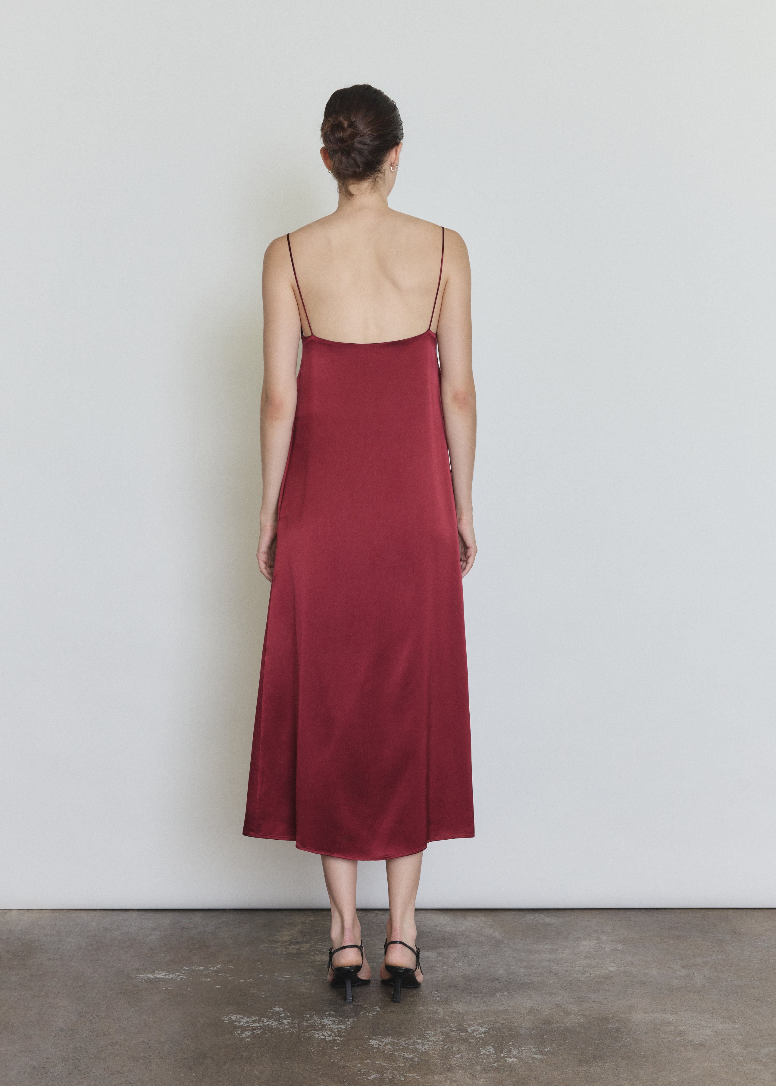 Back view of the bordeaux silk charmeuse Kamperett Agnes Slip Dress with straight-cut back and corded straps.