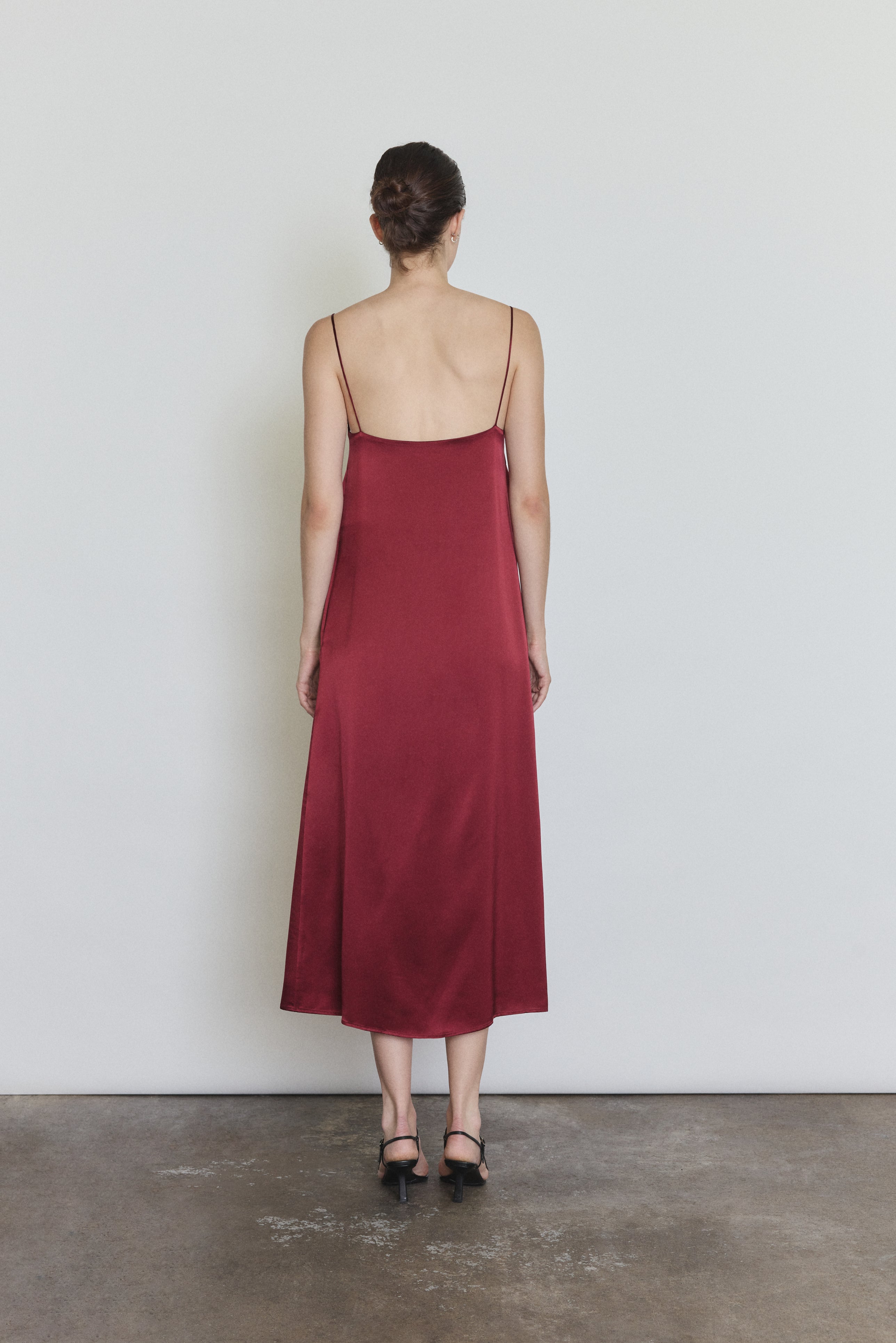 Back view of the bordeaux silk charmeuse Kamperett Agnes Slip Dress with straight-cut back and corded straps.