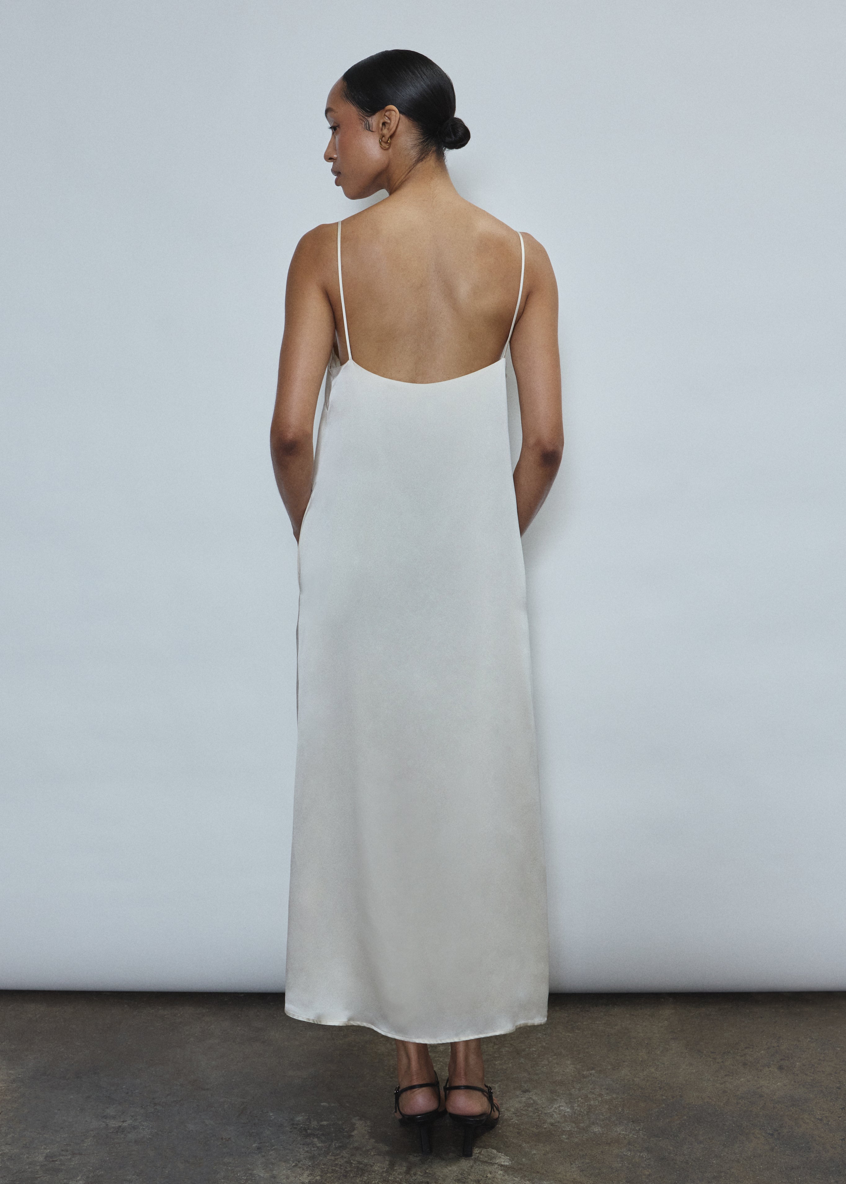 Back view of the ivory silk charmeuse Kamperett Agnes Slip Dress with straight-cut back and fixed corded straps.