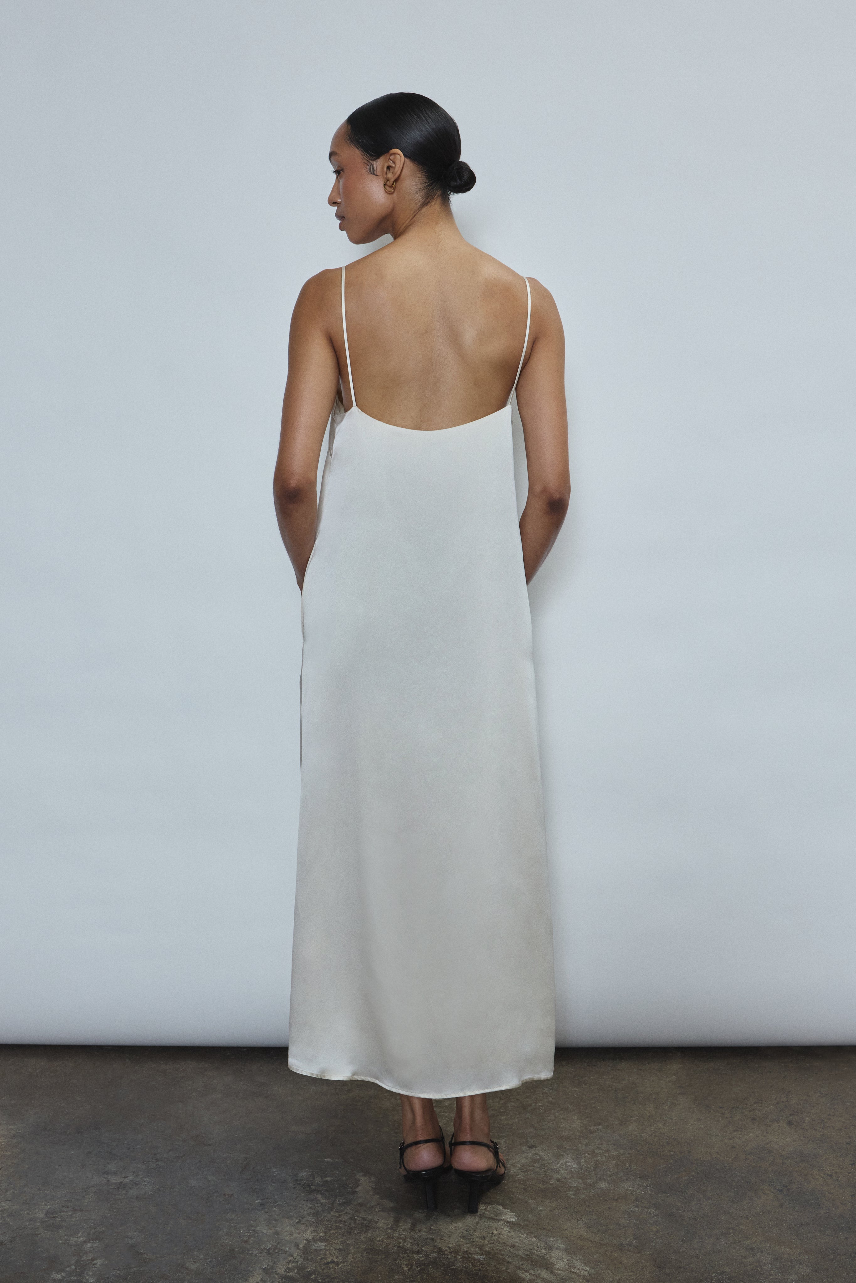Back view of the ivory silk charmeuse Kamperett Agnes Slip Dress with straight-cut back and fixed corded straps.