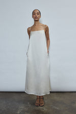 Detail of the ivory silk charmeuse Kamperett Agnes Slip Dress showing the fabric and corded strap construction.