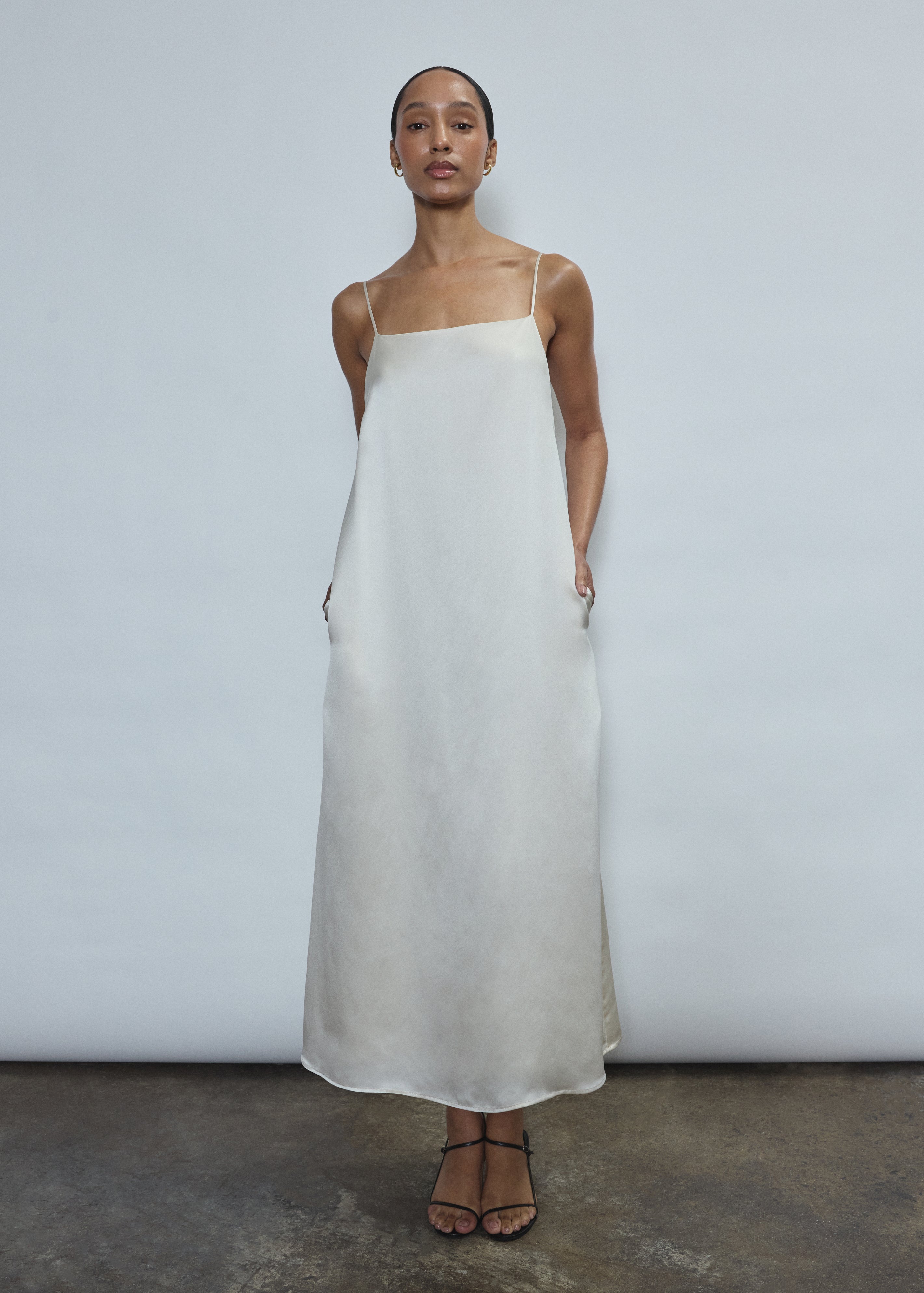 Detail of the ivory silk charmeuse Kamperett Agnes Slip Dress showing the fabric and corded strap construction.
