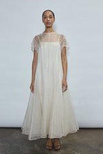 Bride wearing the ivory Kamperett Agnes Slip Dress layered under the Anemoia Midi Dress as a bridal underlayer.