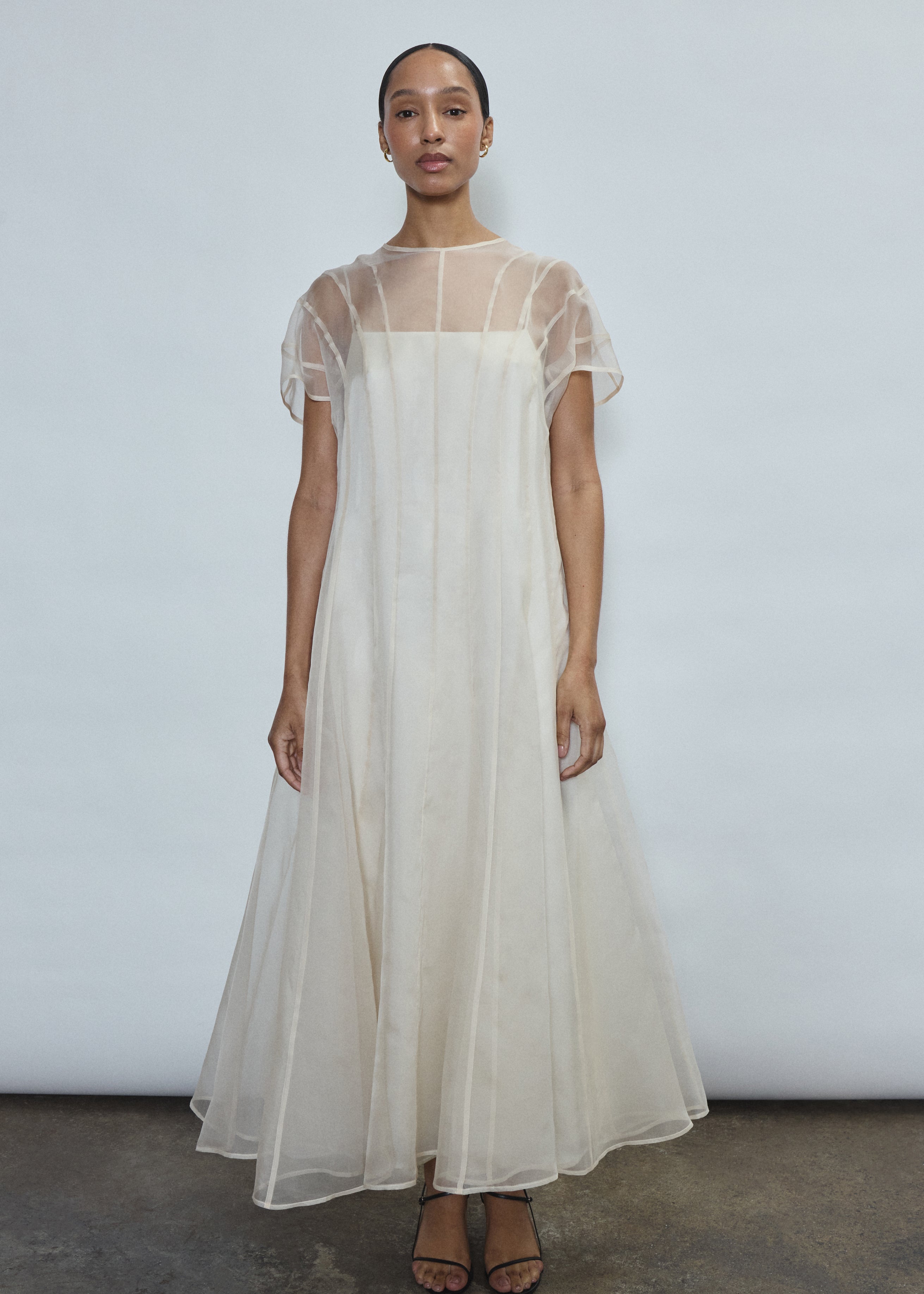 Bride wearing the ivory Kamperett Agnes Slip Dress layered under the Anemoia Midi Dress as a bridal underlayer.
