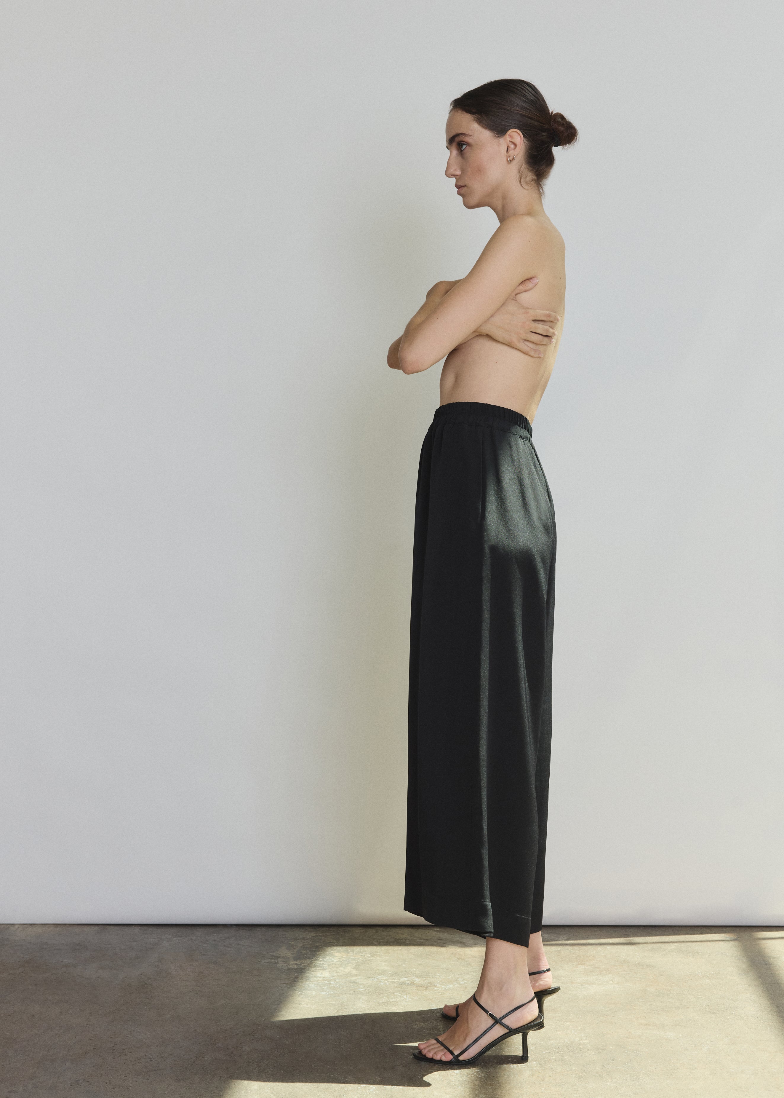 Back view of the black silk crepe Kamperett Alix Silk Crepe Pant showing the pull-on elastic waistband.