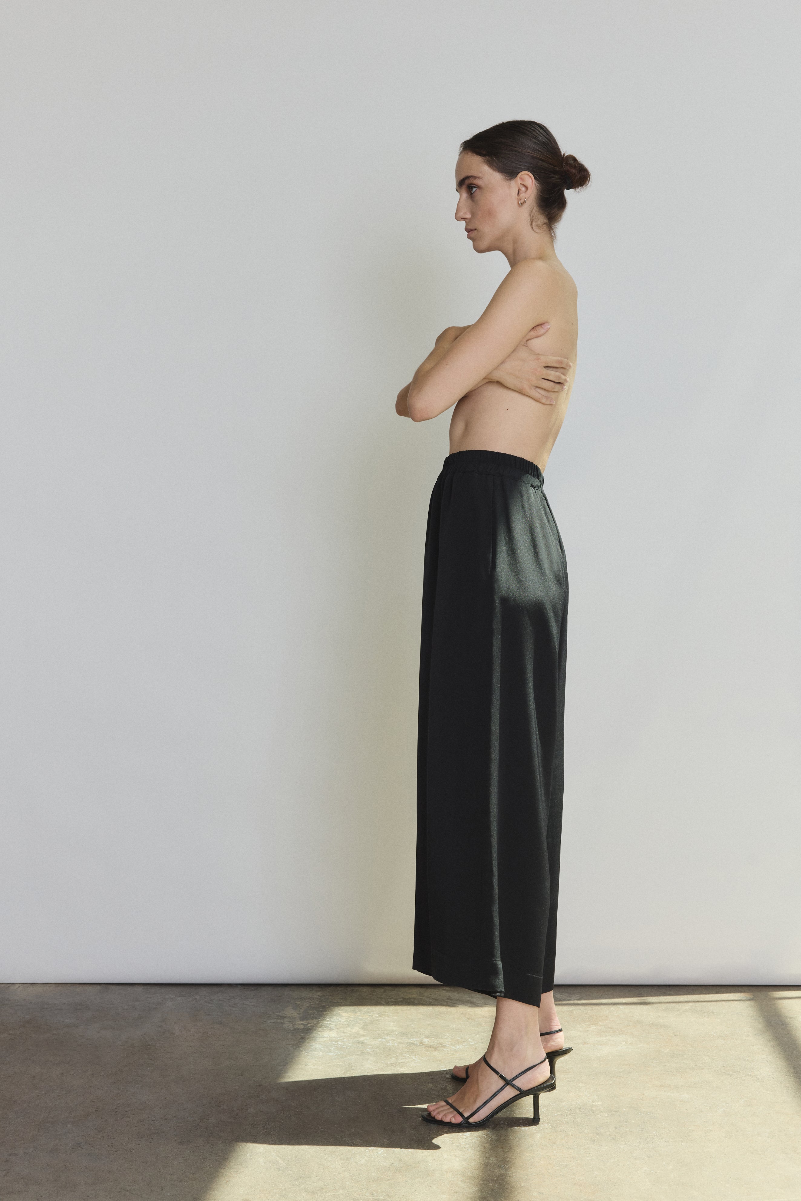 Back view of the black silk crepe Kamperett Alix Silk Crepe Pant showing the pull-on elastic waistband.