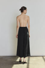 Side view of the black silk crepe Kamperett Alix Silk Crepe Pant showing the wide-leg silhouette and inseam pockets.