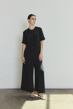 Model wearing the black Kamperett Alix Silk Crepe Pant styled with the Jette Silk Crepe Tee in Black.