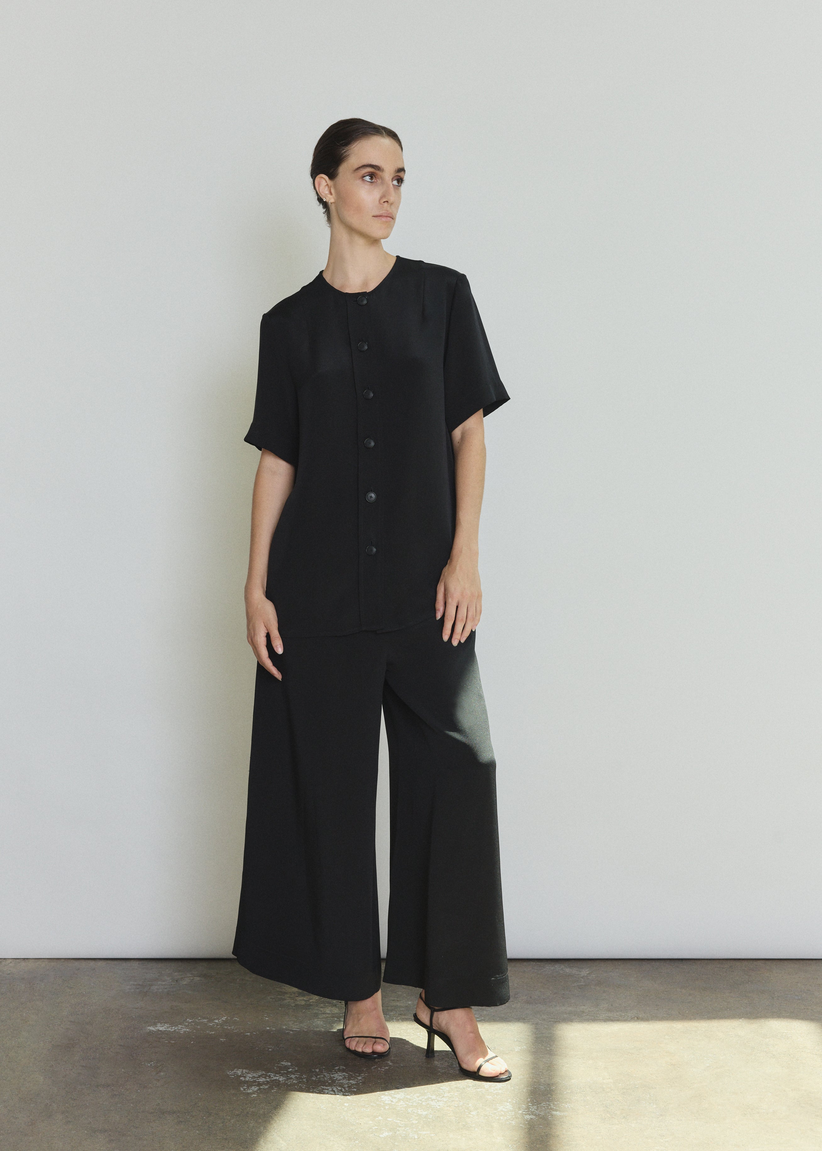 Model wearing the black Kamperett Alix Silk Crepe Pant styled with the Jette Silk Crepe Tee in Black.