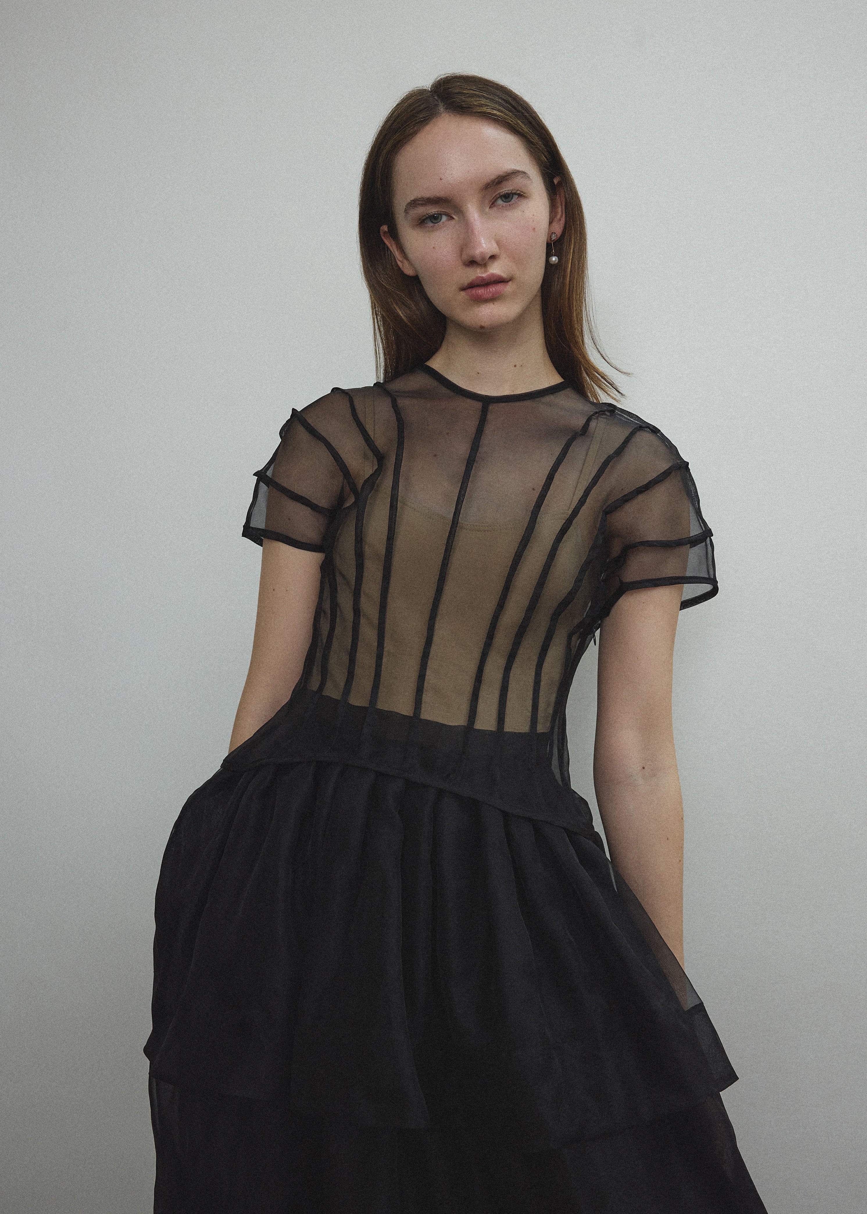 Model wearing the Kamperett Anemoia Blouse in Black silk organza, highlighting the voluminous sculptural sleeves and elegant mock neck silhouette.