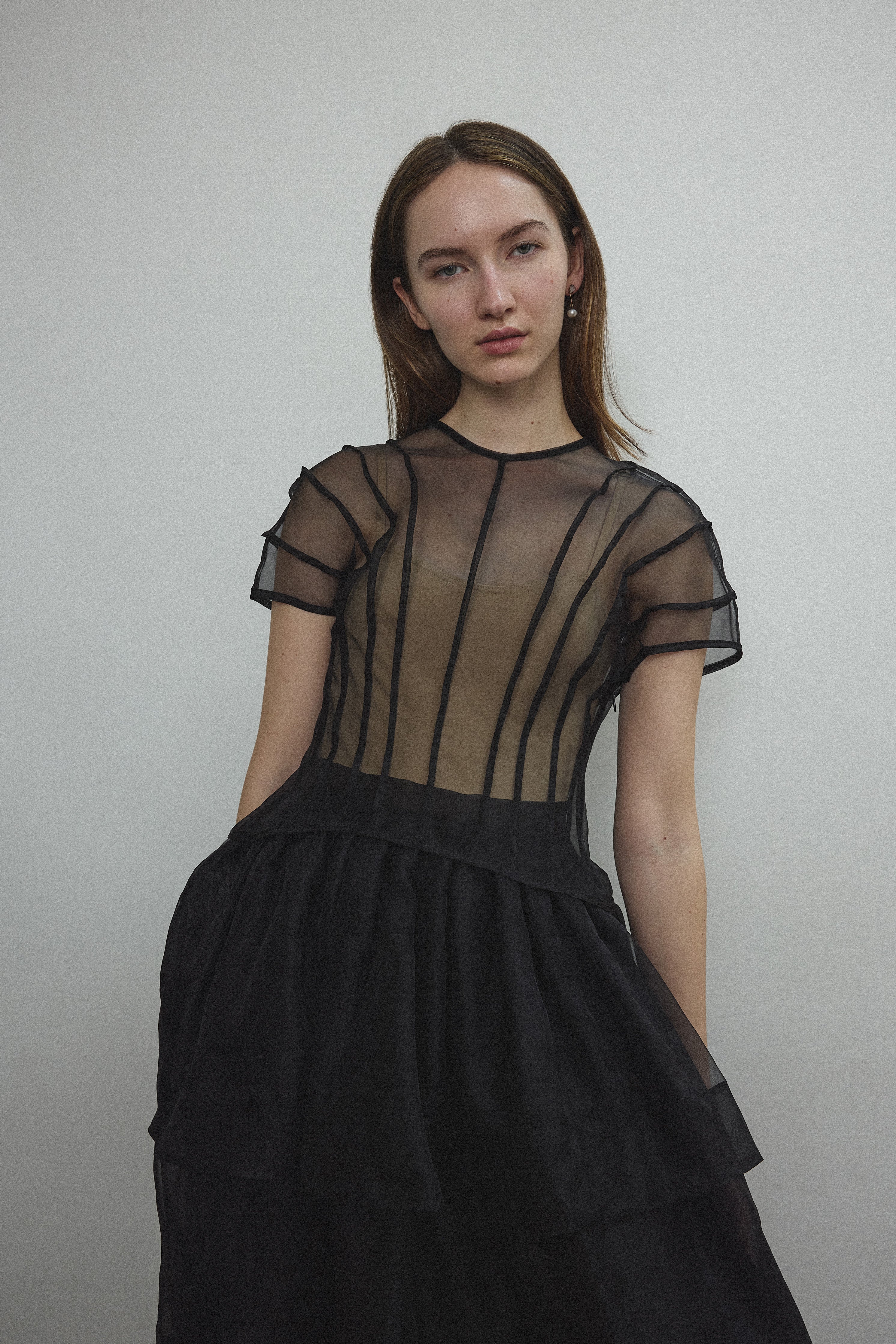 Model wearing the Kamperett Anemoia Blouse in Black silk organza, highlighting the voluminous sculptural sleeves and elegant mock neck silhouette.