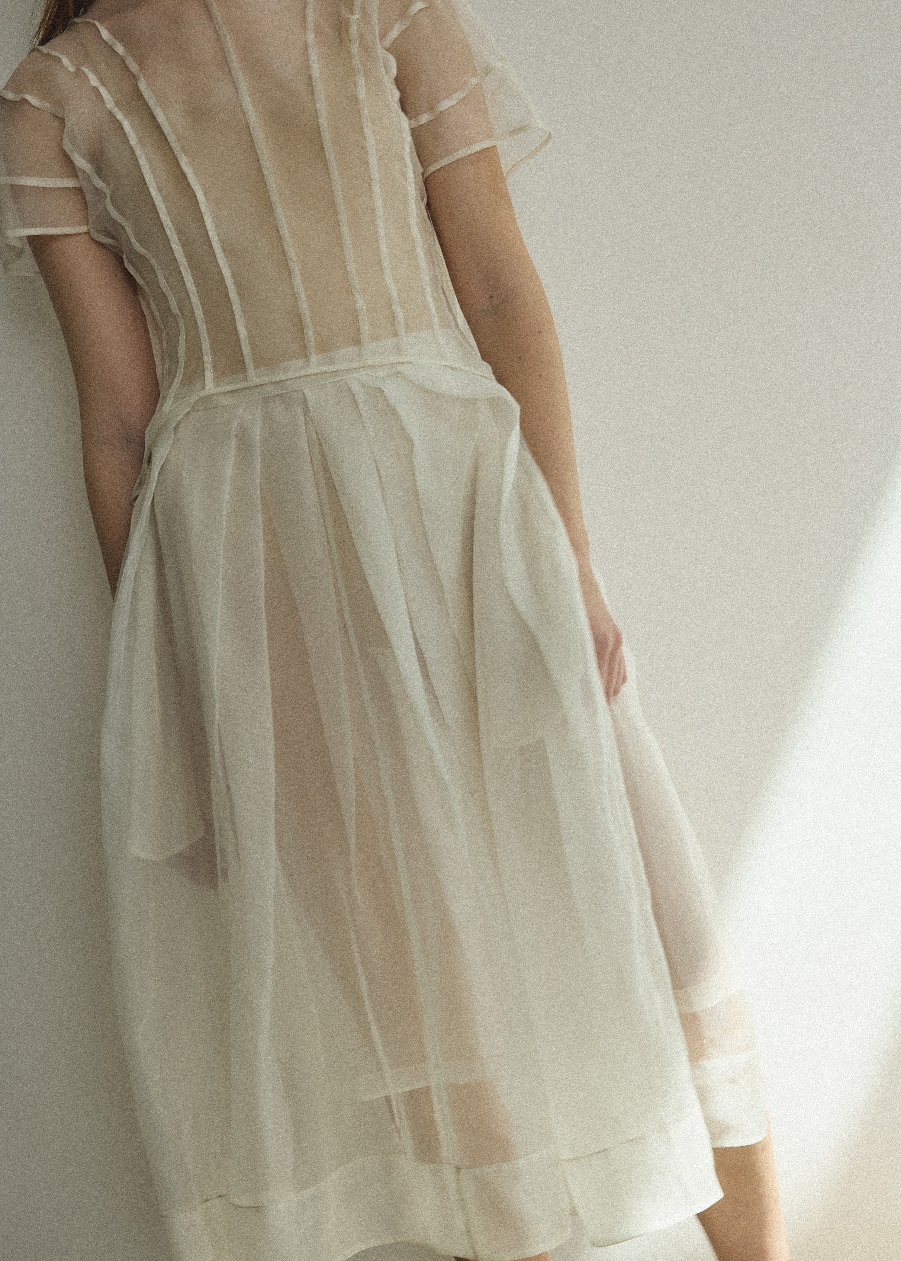 Model wearing the Kamperett Anemoia Blouse in Ivory silk organza, highlighting the voluminous sculptural sleeves and elegant mock neck silhouette.