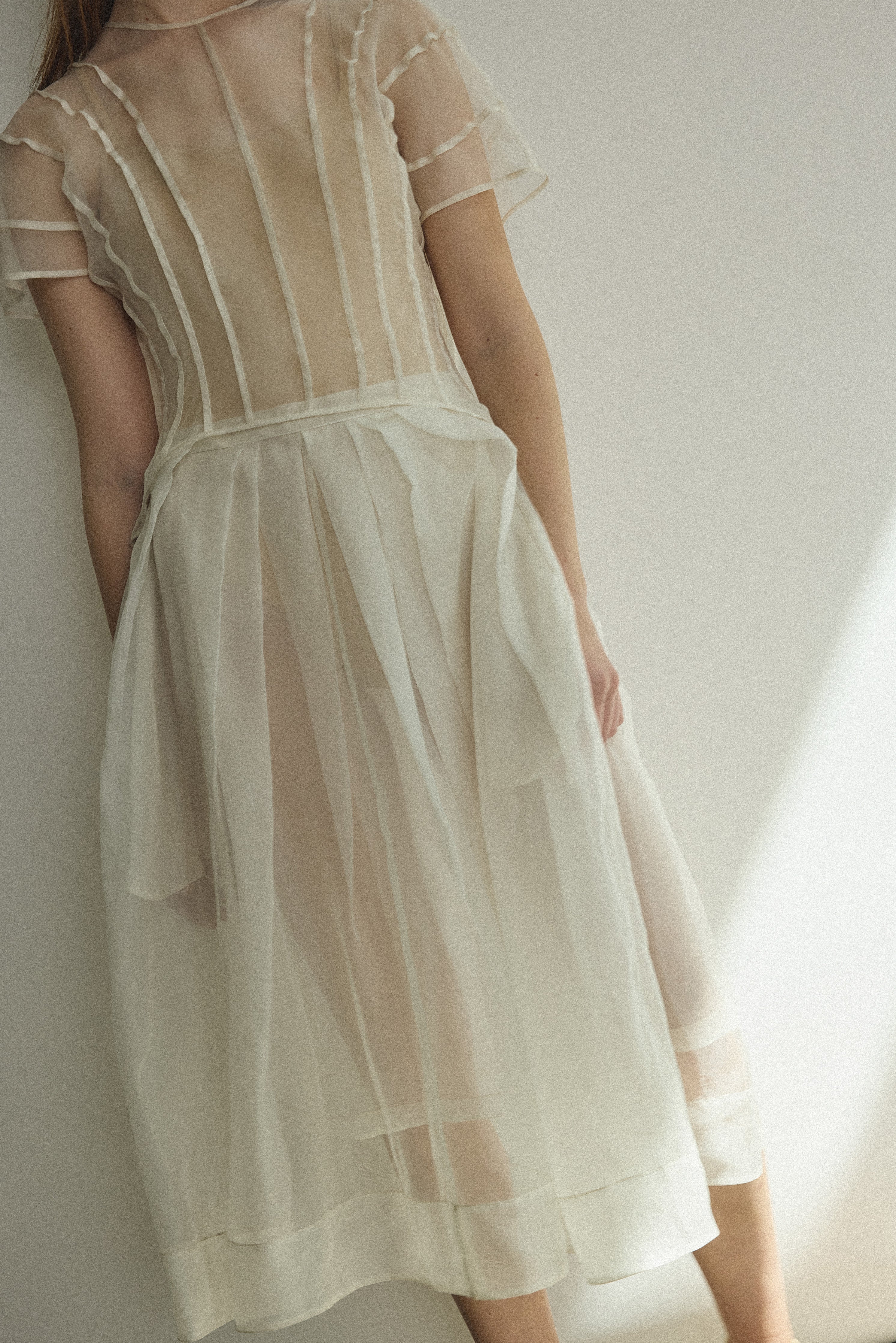 Model wearing the Kamperett Anemoia Blouse in Ivory silk organza, highlighting the voluminous sculptural sleeves and elegant mock neck silhouette.