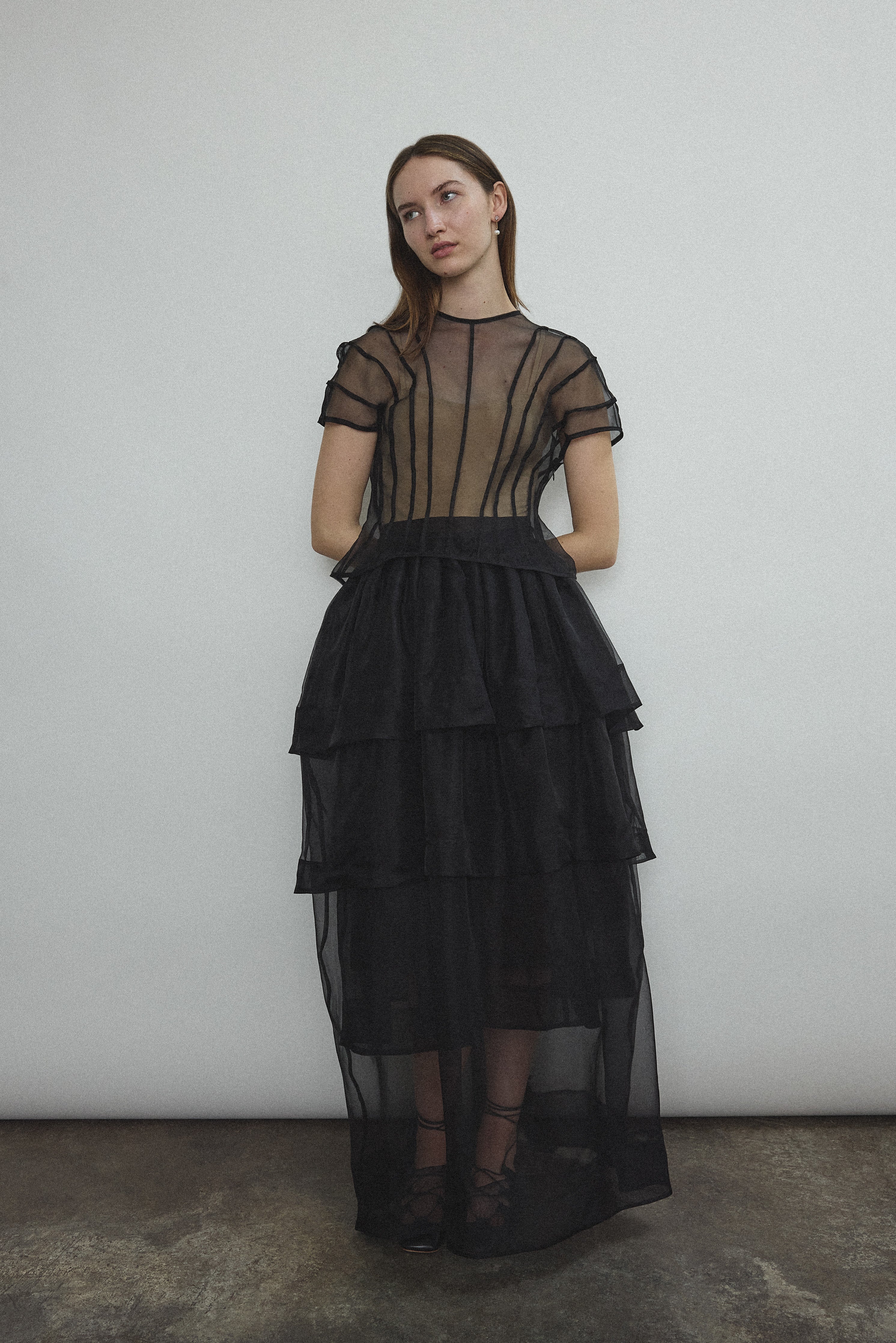 Model wearing the Kamperett Anemoia Blouse in Black silk organza, highlighting the voluminous sculptural sleeves and elegant mock neck silhouette.