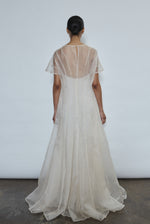 Model wearing the voluminous Kamperett Anemoia Gown in Ivory silk organza, featuring architectural French seams and a graceful floor-length silhouette.