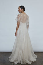 Model wearing the voluminous Kamperett Anemoia Gown in Ivory silk organza, featuring architectural French seams and a graceful floor-length silhouette.