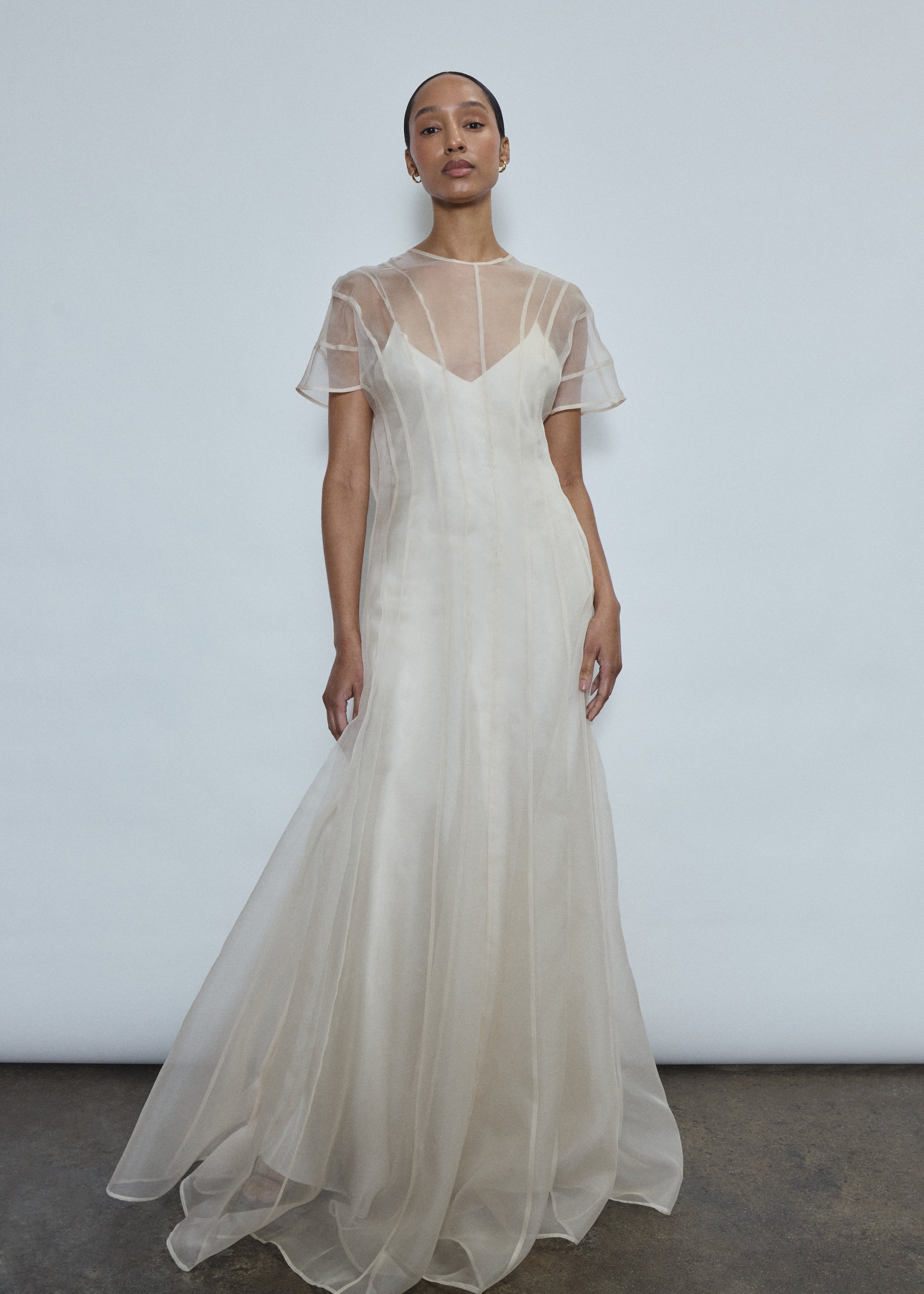 Ivory silk organza sheath gown with French lace, mock neck, deconstructed cap sleeves & raw hem. Minimalist occasion wear, made in California.