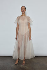 Model wearing the voluminous Kamperett Anemoia Midi dress in Ivory silk organza, highlighting the architectural French seams and graceful midi-length silhouette.