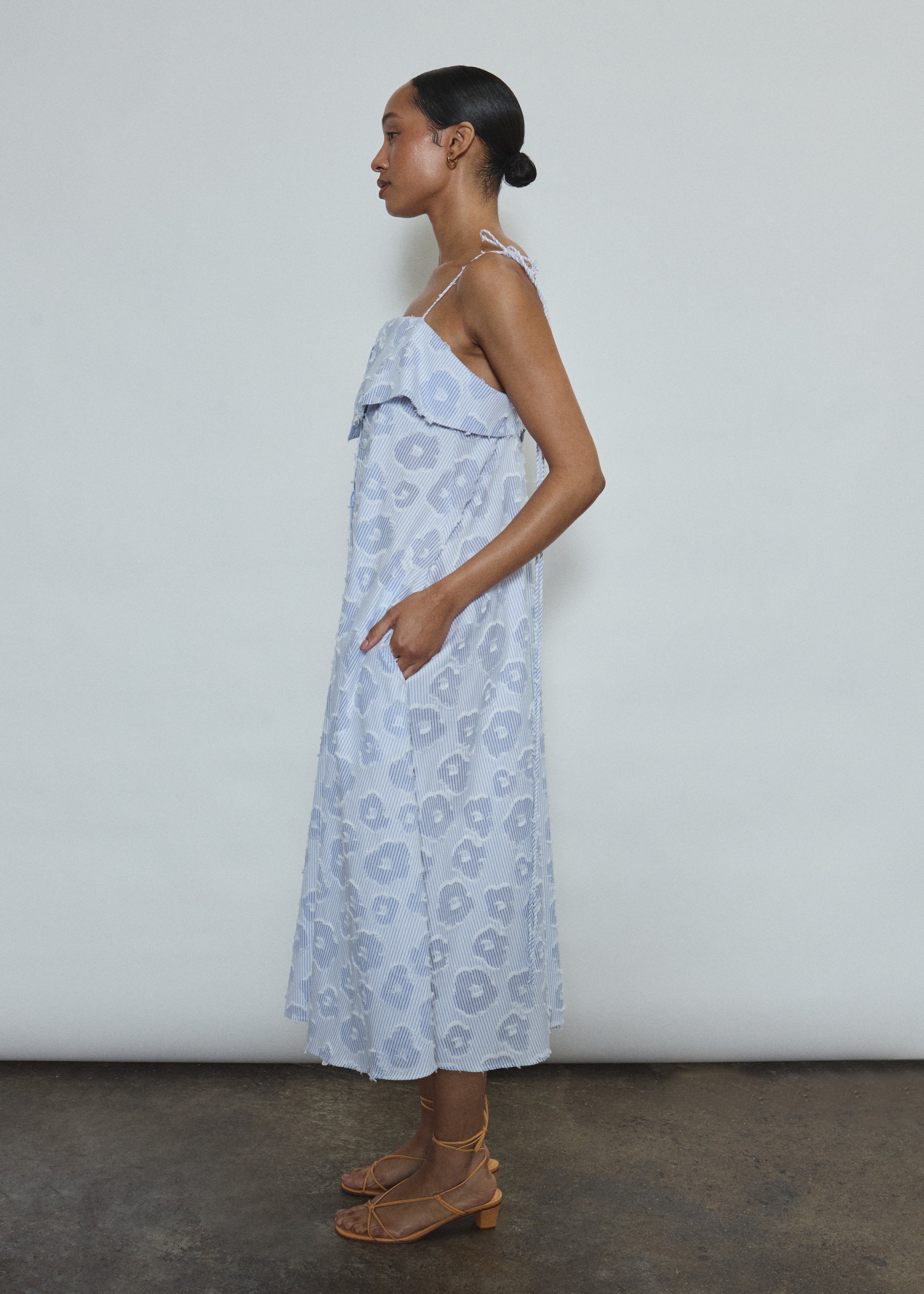 Model wearing the black Kamperett Anis Dress in blue floral. An a-line midi dress constructed from 100% mid weight Japanese cotton. 