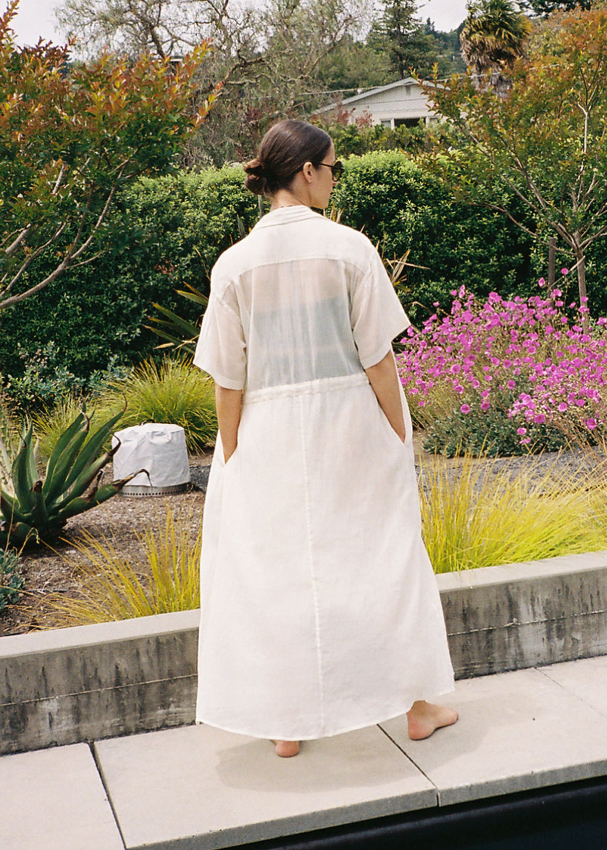 Editorial image of the white semi-sheer Japanese cotton voile Kamperett Antoine Shirt Dress.