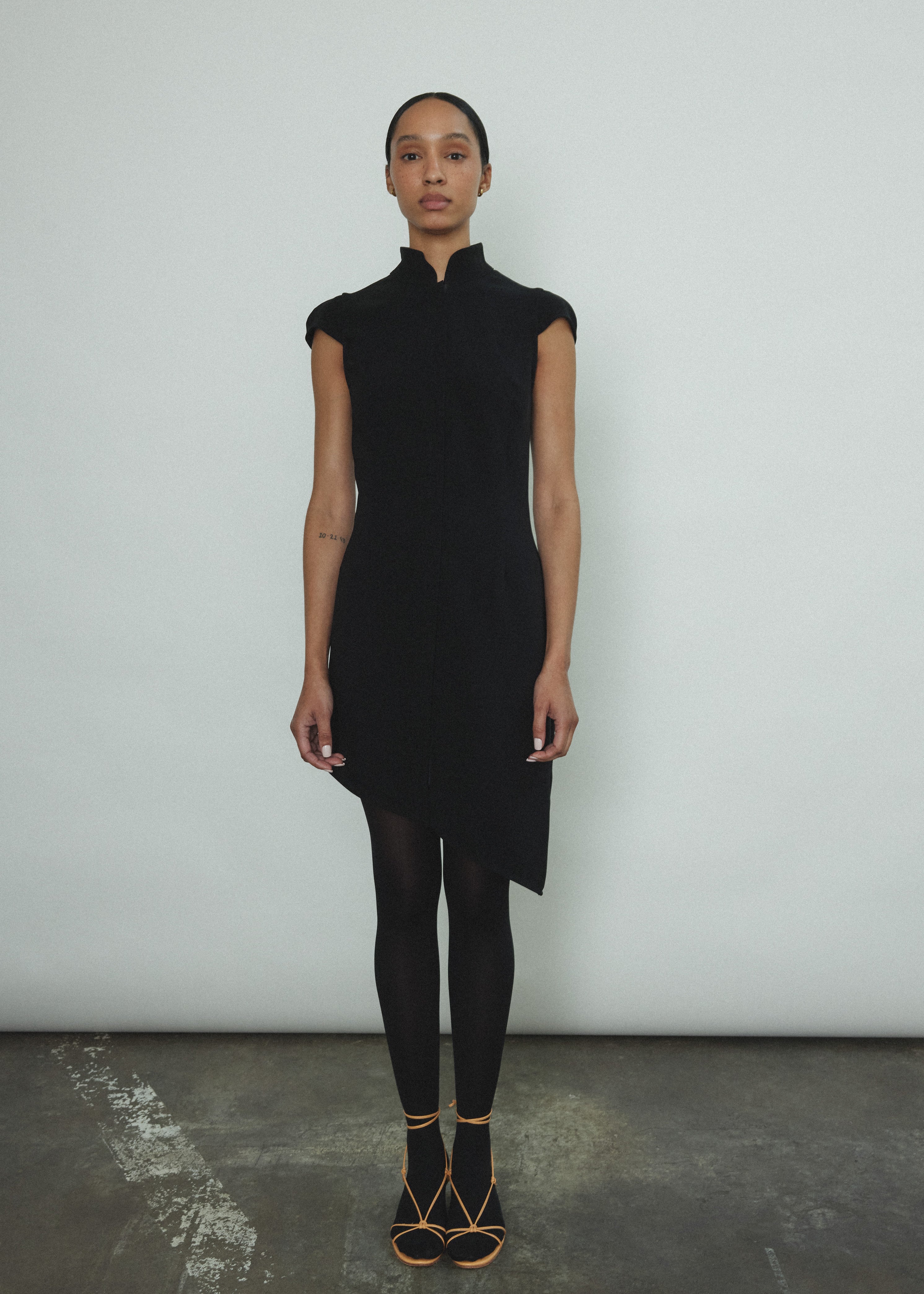 Editorial image of the black wool flannel Kamperett Astrid Vest with silk lining.