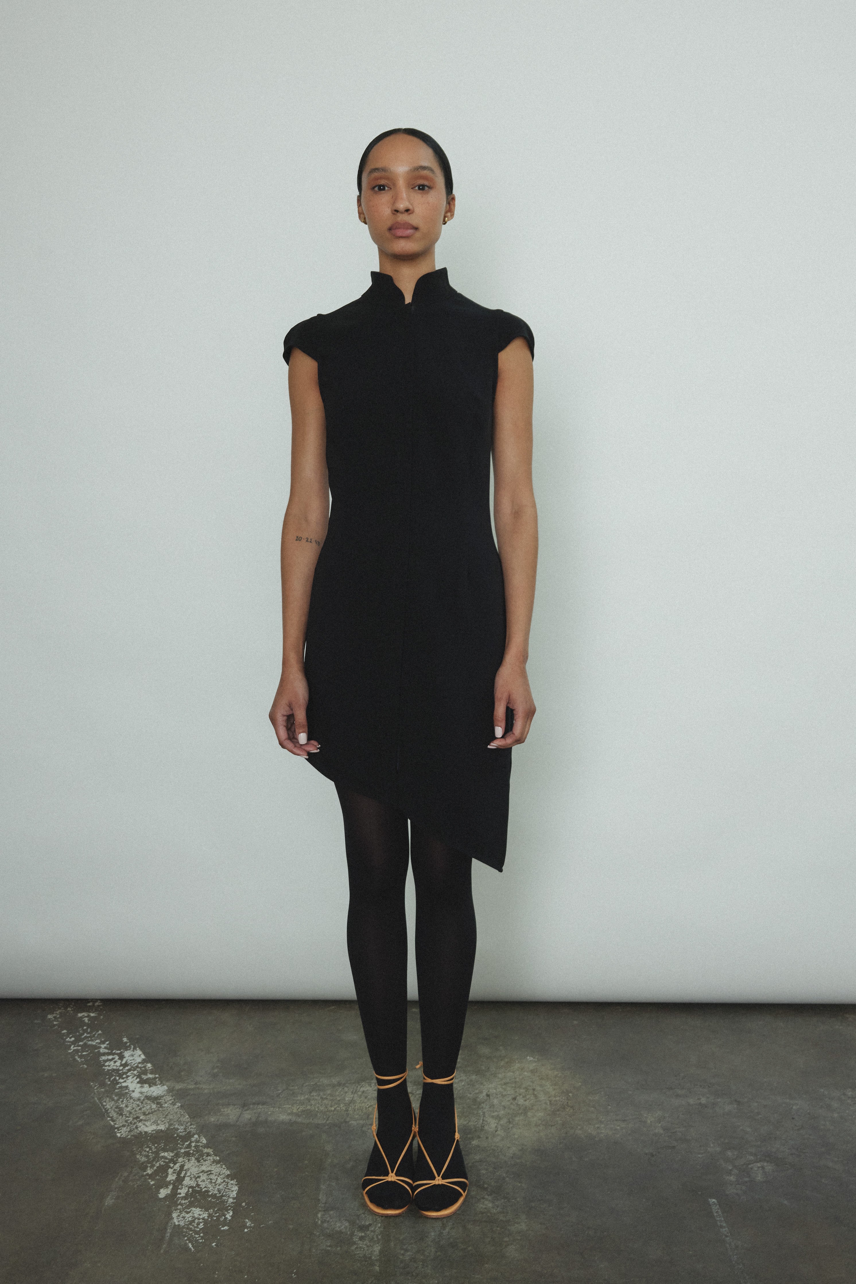 Editorial image of the black wool flannel Kamperett Astrid Vest with silk lining.