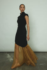 Side view of the black wool flannel Kamperett Astrid Vest showing the asymmetric hemline.