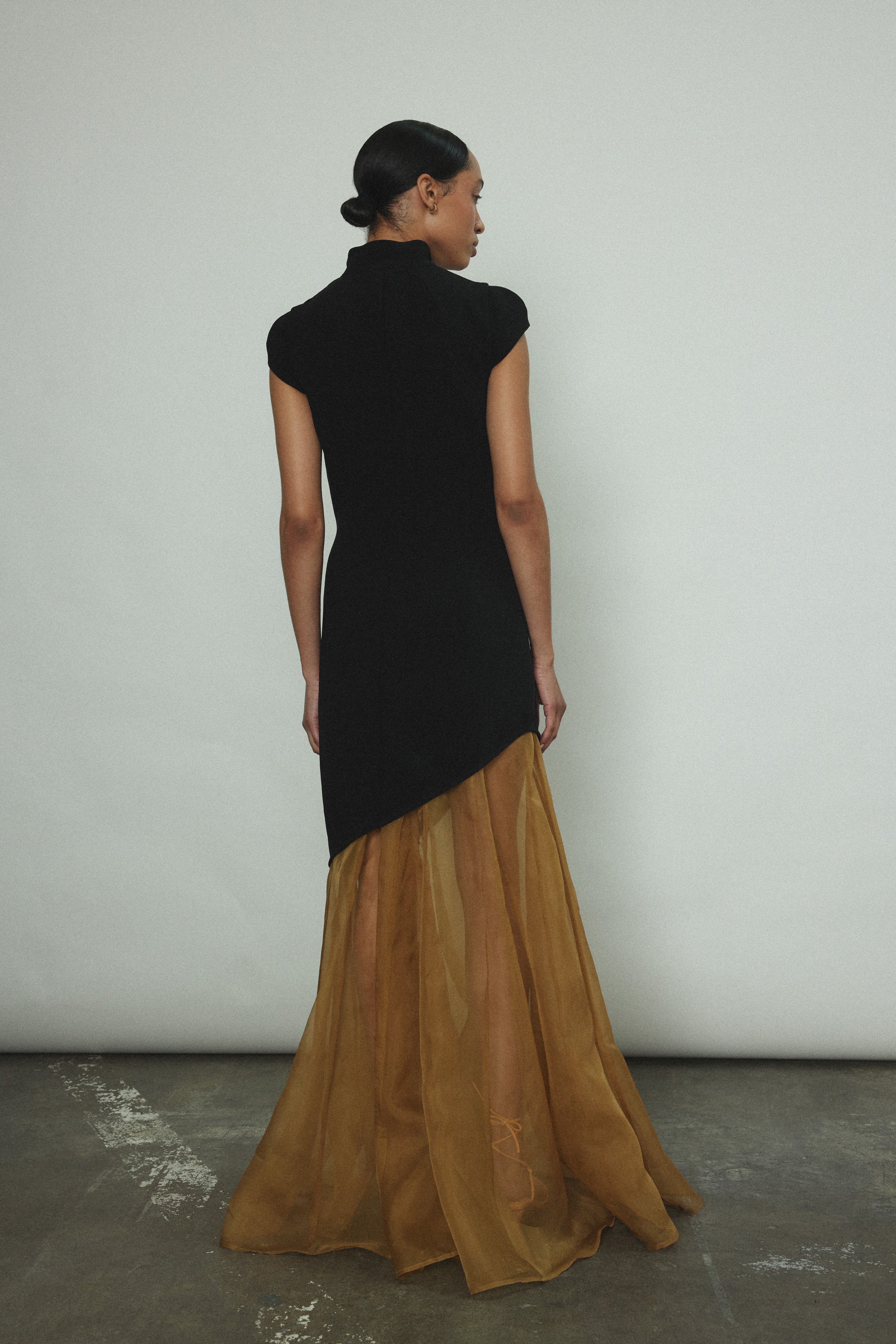 The black Kamperett Astrid Vest styled with the Lalique Gown for a layered occasion look.