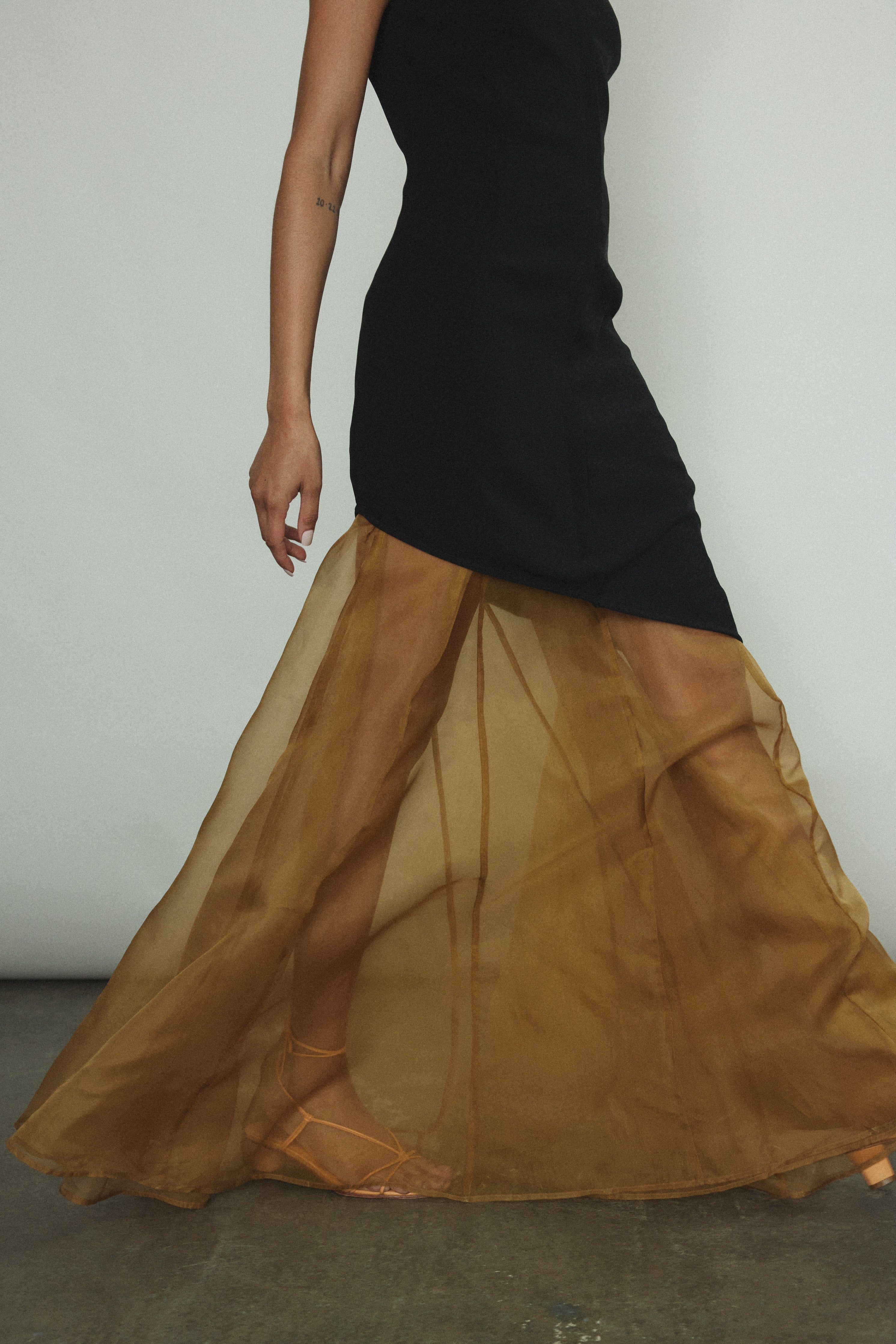 Side view of the black Kamperett Astrid Vest styled with the Lalique Gown.