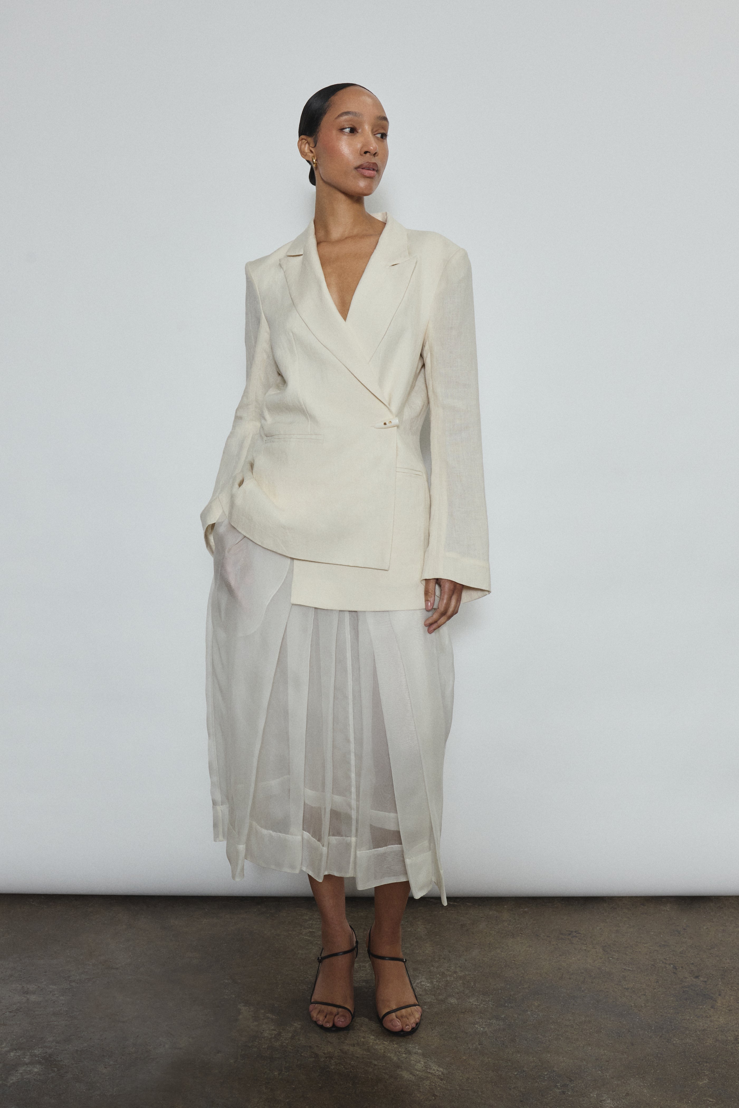 Model wearing the Alabaster silk organza Brise Skirt, showcasing its voluminous silhouette, sheer fabric, and elegant midi-length drape.