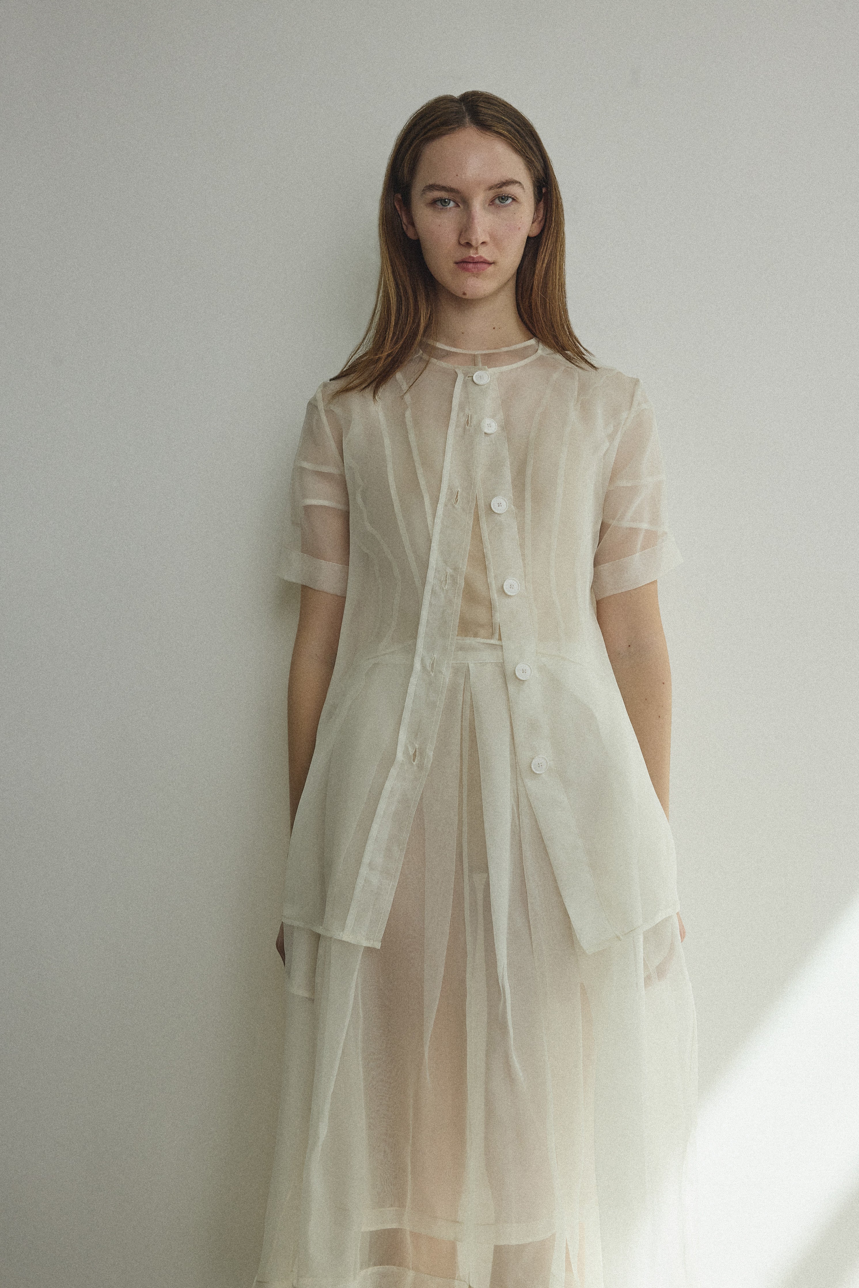 Model wearing the Alabaster silk organza Brise Skirt, showcasing its voluminous silhouette, sheer fabric, and elegant midi-length drape.