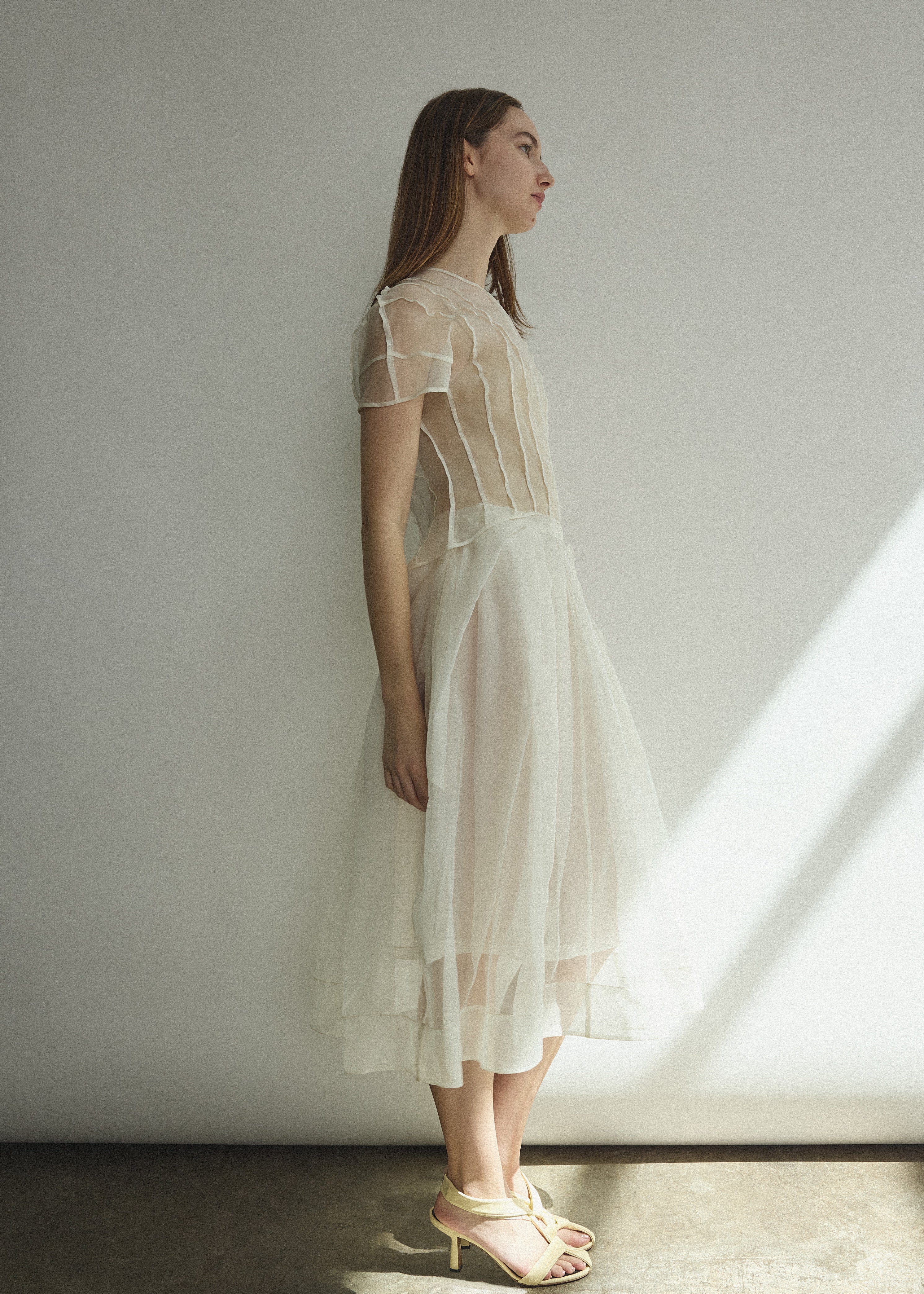 Model wearing the Alabaster silk organza Brise Skirt, showcasing its voluminous silhouette, sheer fabric, and elegant midi-length drape.