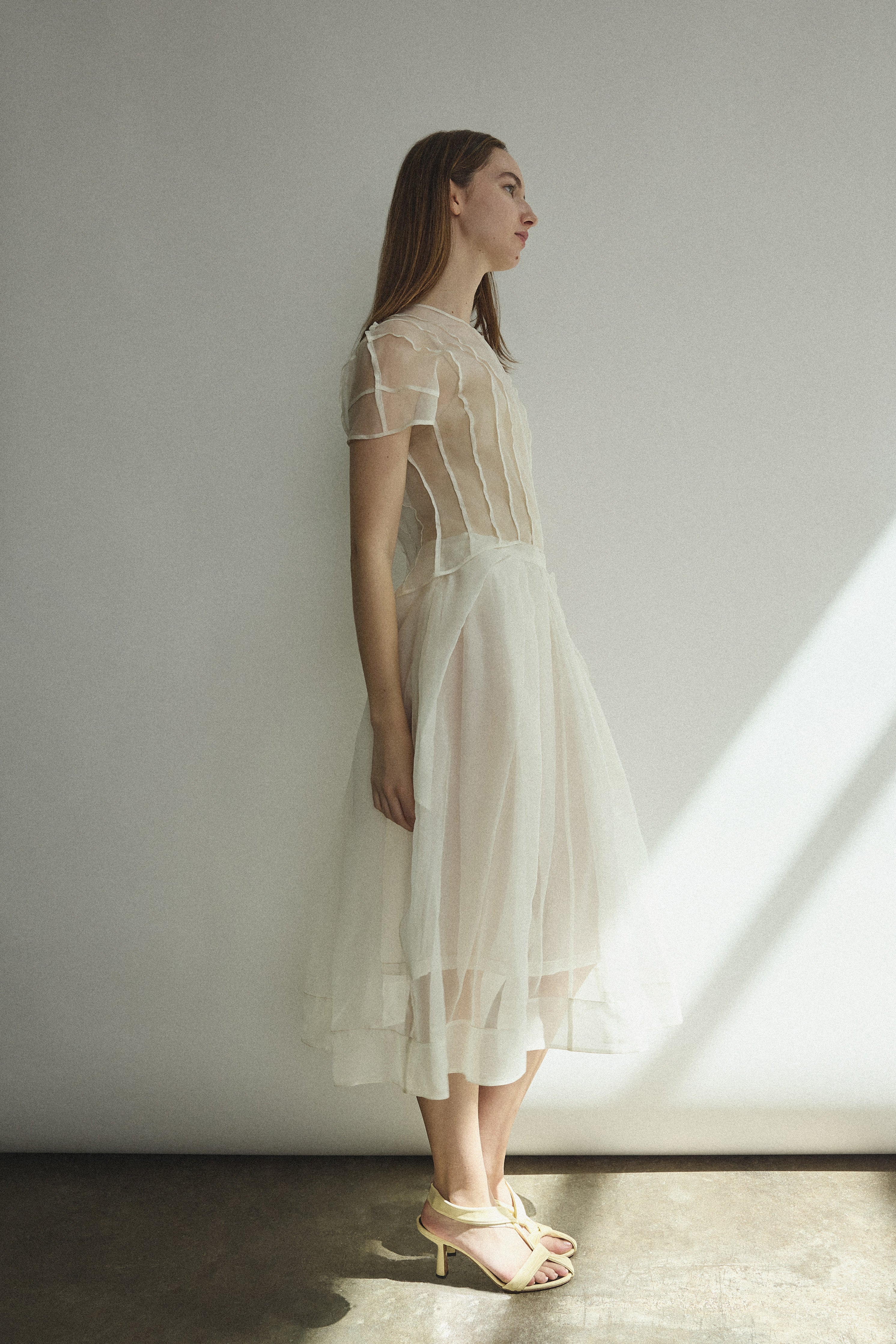 Model wearing the Alabaster silk organza Brise Skirt, showcasing its voluminous silhouette, sheer fabric, and elegant midi-length drape.