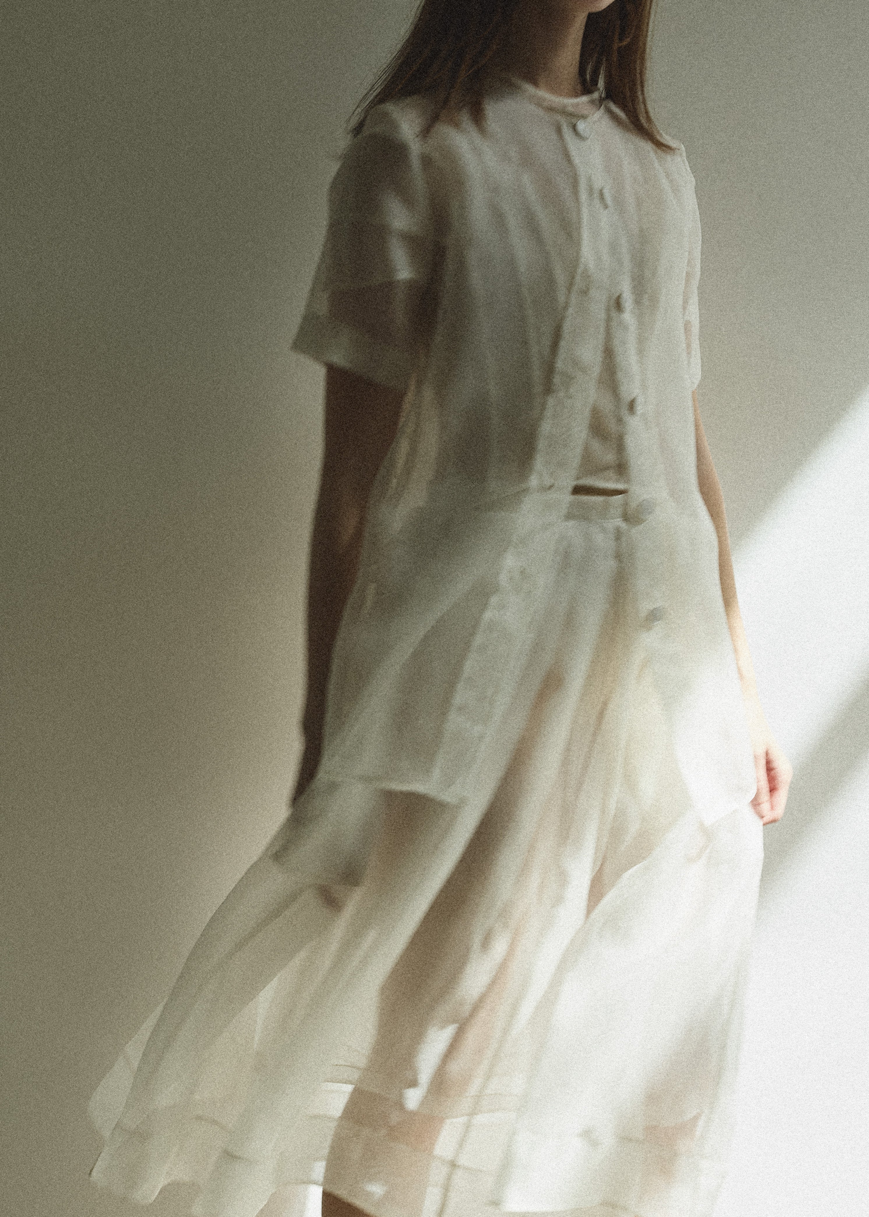 Model wearing the Alabaster silk organza Brise Skirt, showcasing its voluminous silhouette, sheer fabric, and elegant midi-length drape.