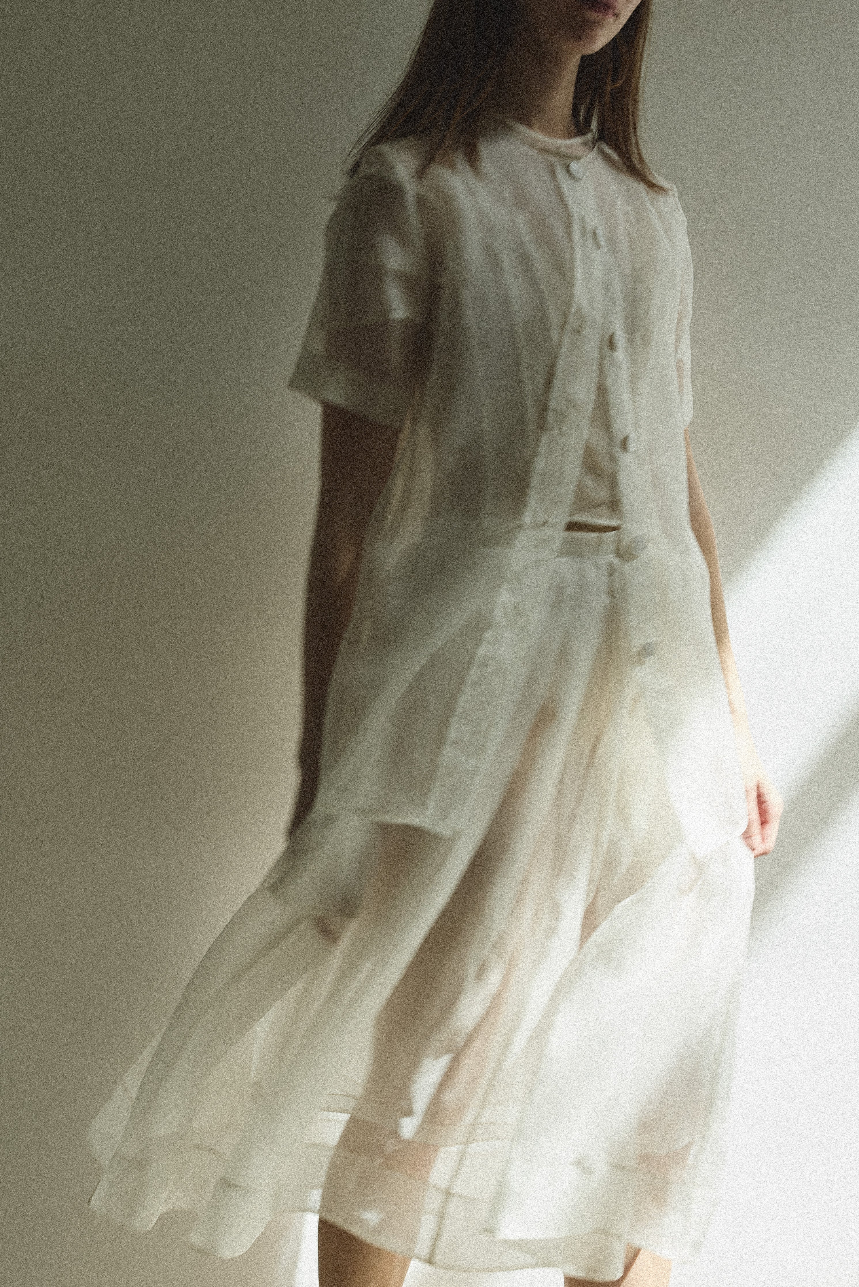 Model wearing the Alabaster silk organza Brise Skirt, showcasing its voluminous silhouette, sheer fabric, and elegant midi-length drape.