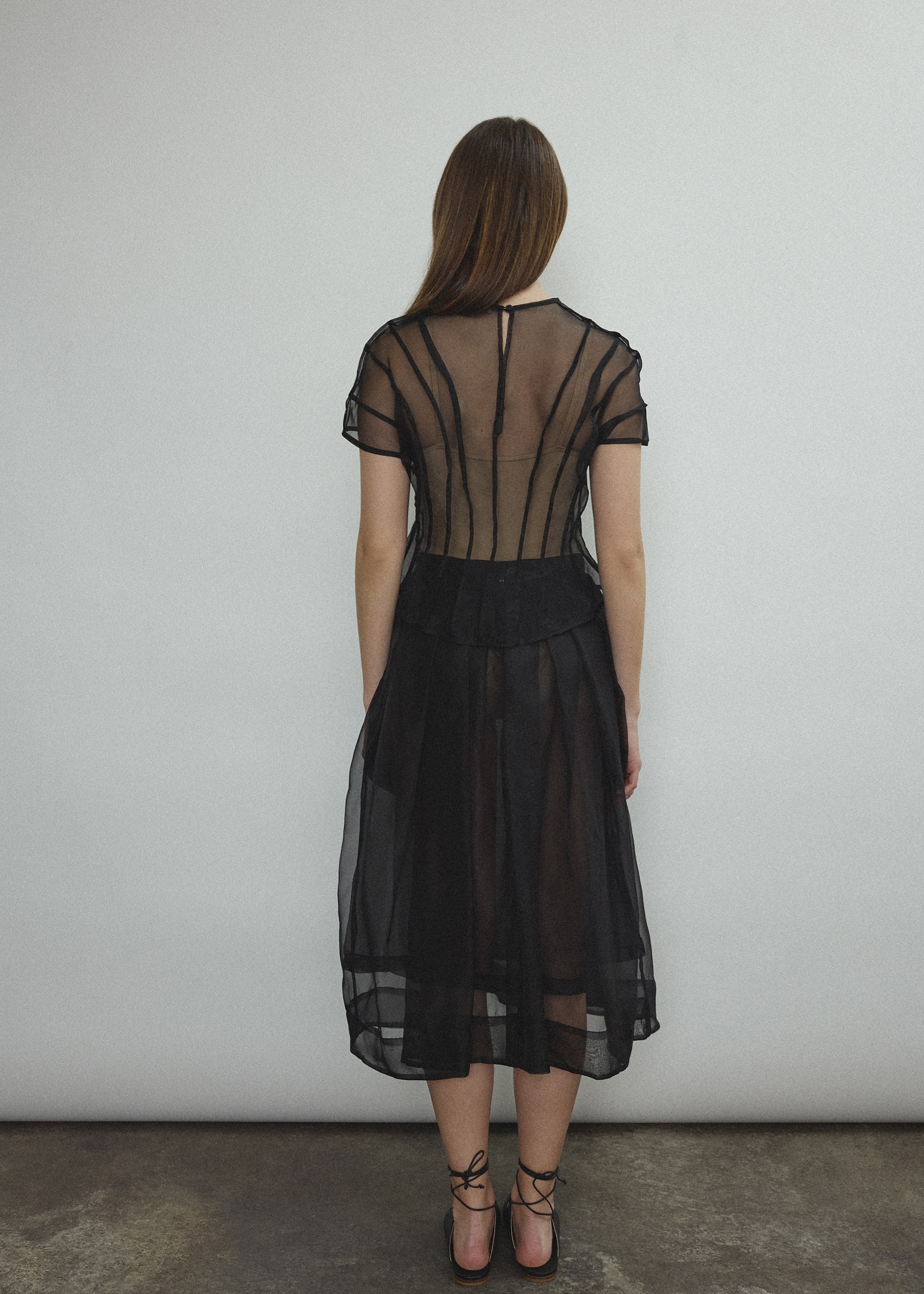 Model wearing the Black silk organza Brise Skirt, showcasing its voluminous silhouette, sheer fabric, and elegant midi-length drape.