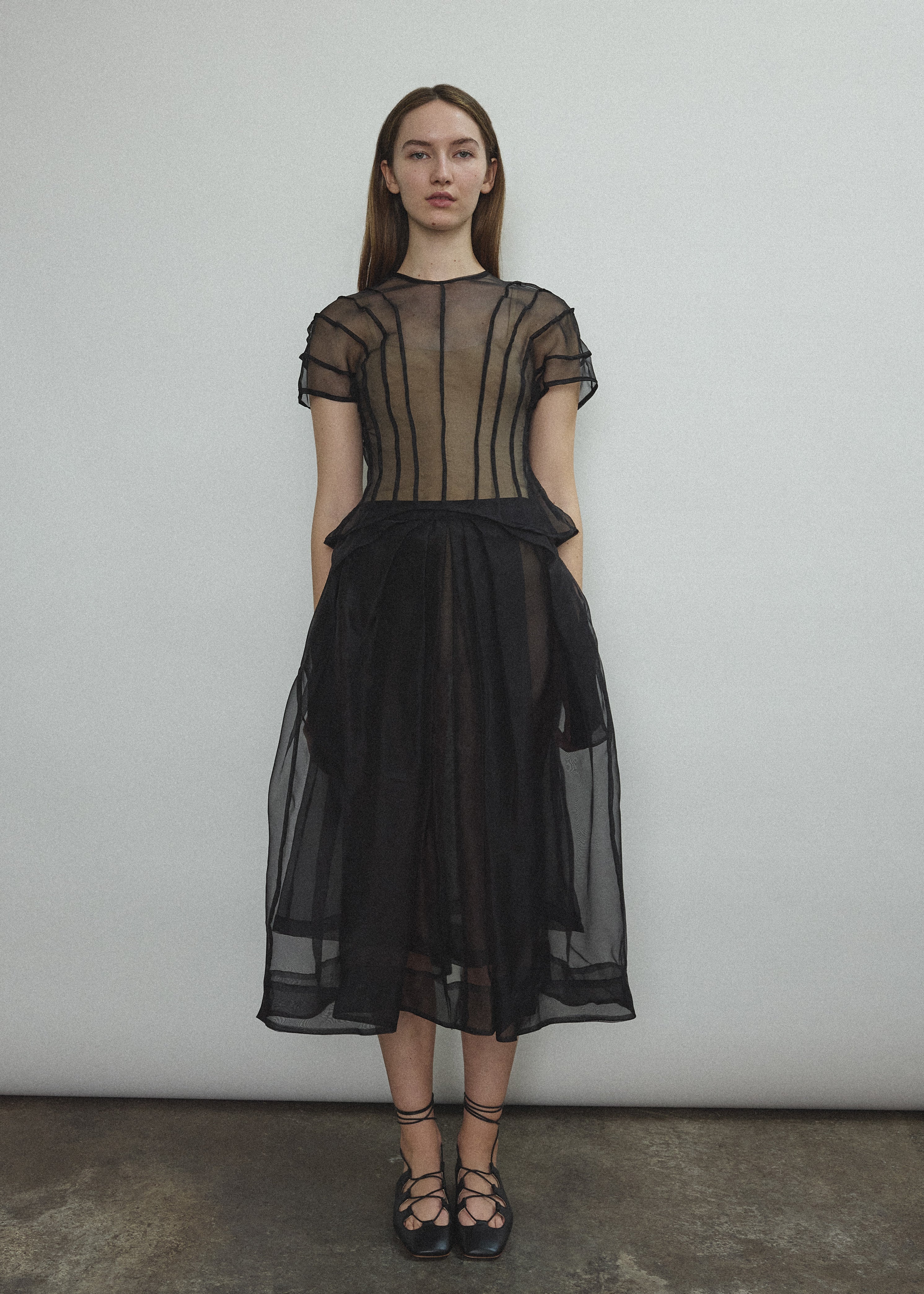 Model wearing the Black silk organza Brise Skirt, showcasing its voluminous silhouette, sheer fabric, and elegant midi-length drape.