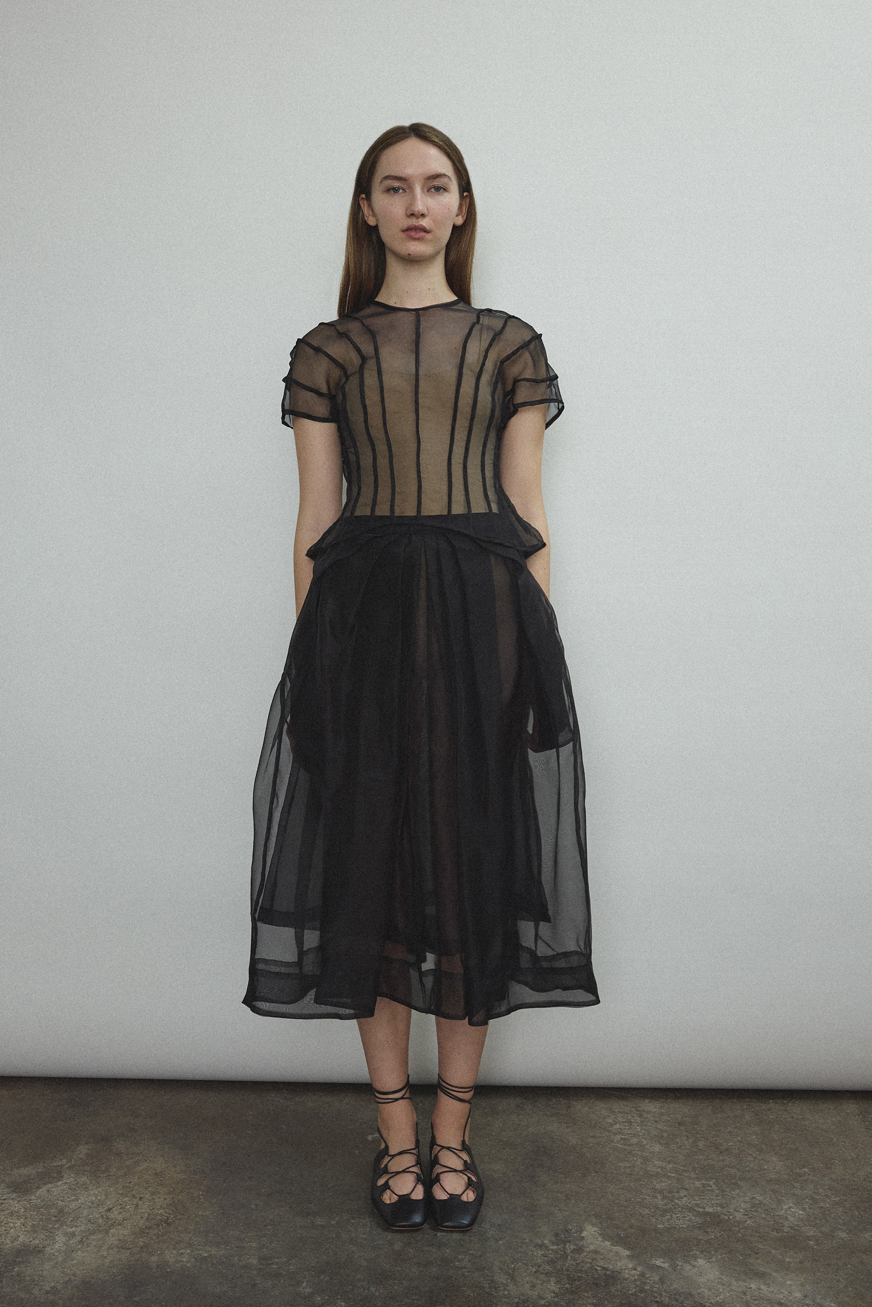 Model wearing the Black silk organza Brise Skirt, showcasing its voluminous silhouette, sheer fabric, and elegant midi-length drape.