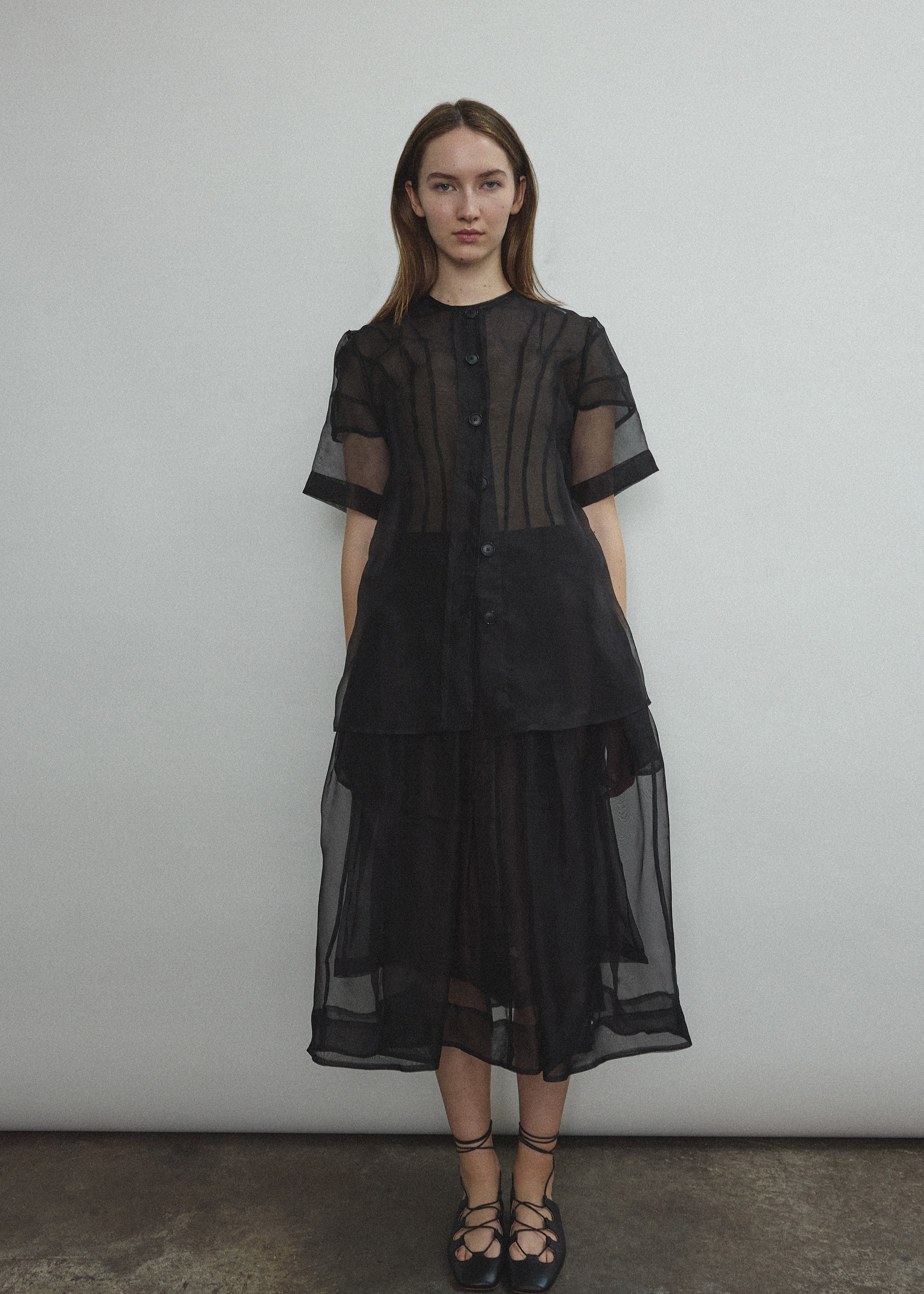 Model wearing the Black silk organza Brise Skirt, showcasing its voluminous silhouette, sheer fabric, and elegant midi-length drape.