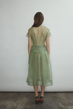 Model wearing the Jade silk organza Brise Skirt, showcasing its voluminous silhouette, sheer fabric, and elegant midi-length drape.