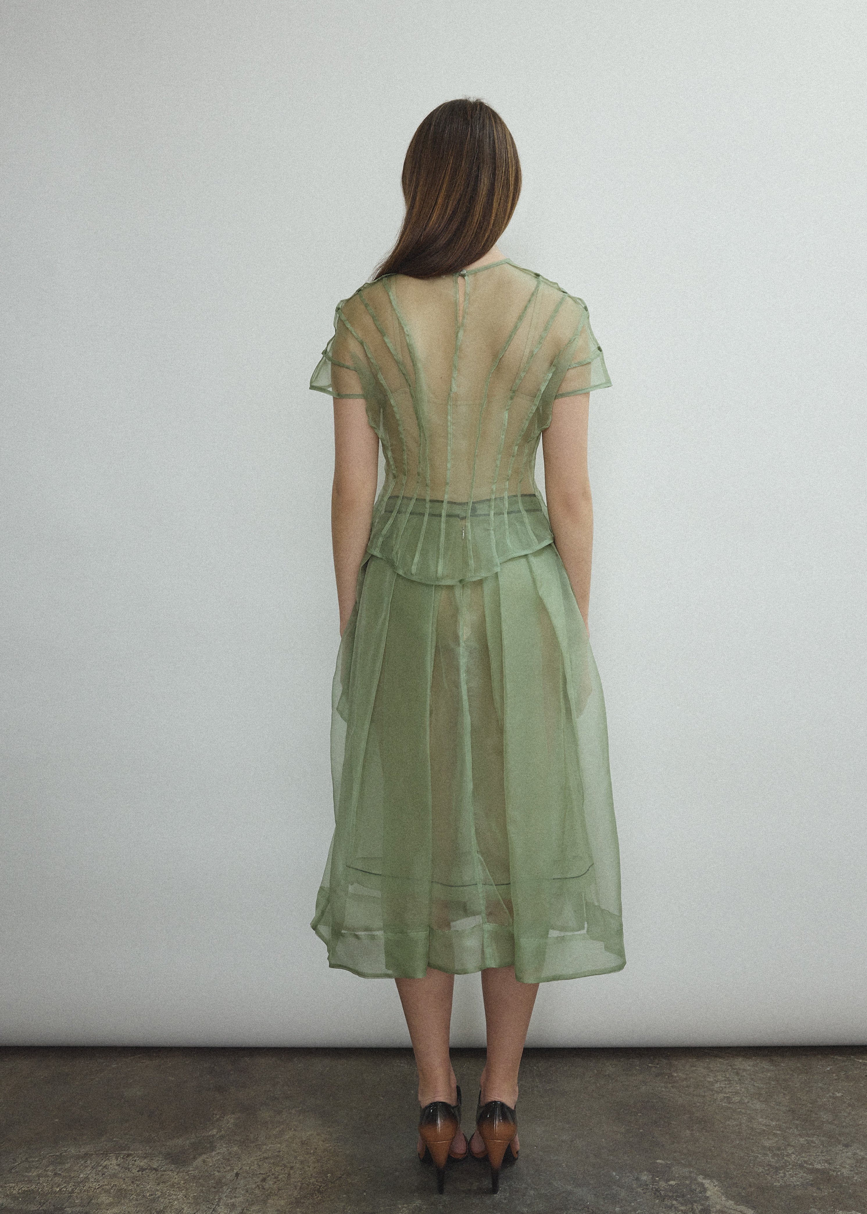 Model wearing the Jade silk organza Brise Skirt, showcasing its voluminous silhouette, sheer fabric, and elegant midi-length drape.