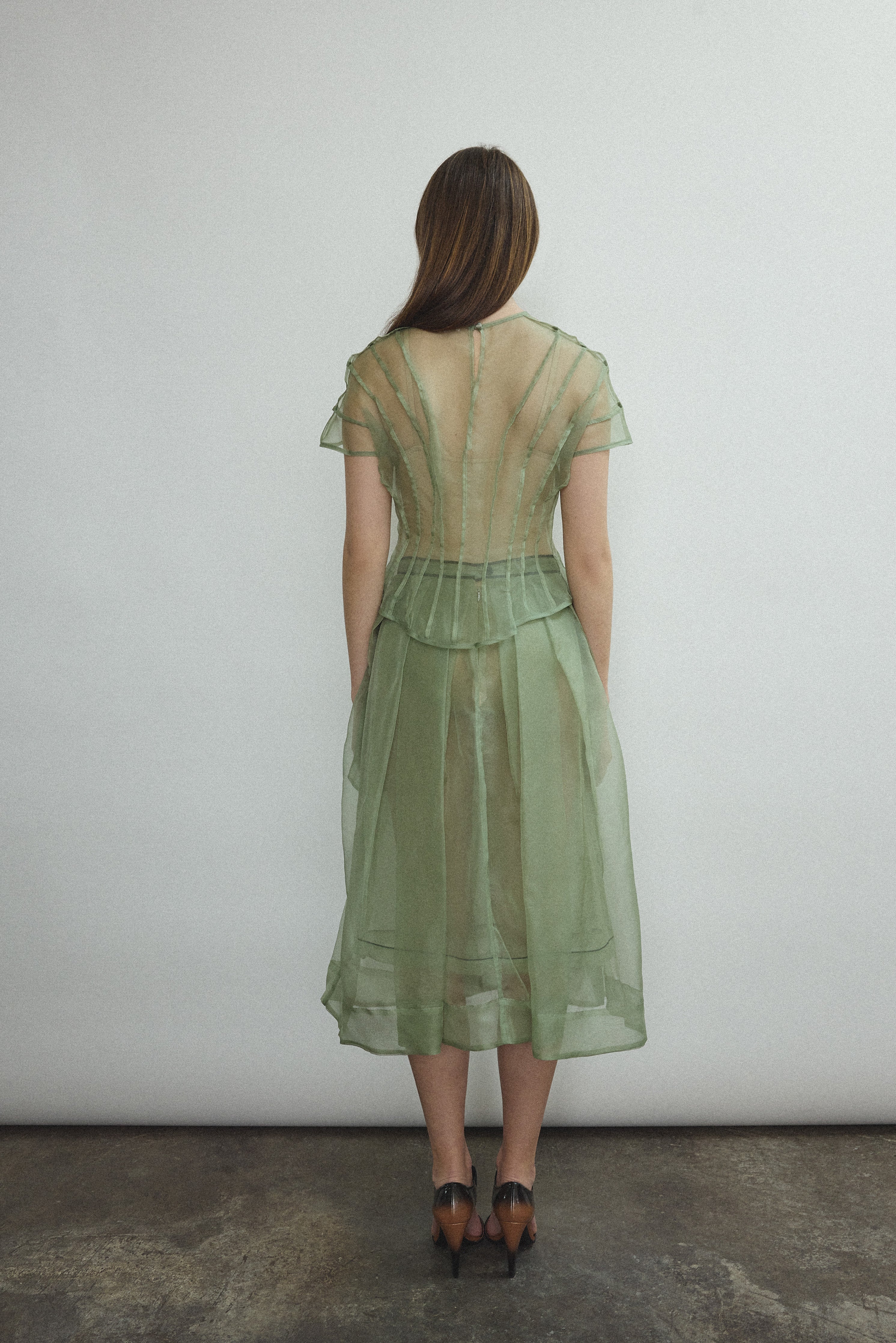 Model wearing the Jade silk organza Brise Skirt, showcasing its voluminous silhouette, sheer fabric, and elegant midi-length drape.