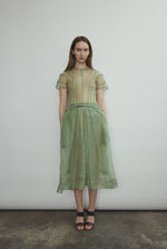 Model wearing the Jade silk organza Brise Skirt, showcasing its voluminous silhouette, sheer fabric, and elegant midi-length drape.