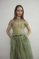Model wearing the Jade silk organza Brise Skirt, showcasing its voluminous silhouette, sheer fabric, and elegant midi-length drape.