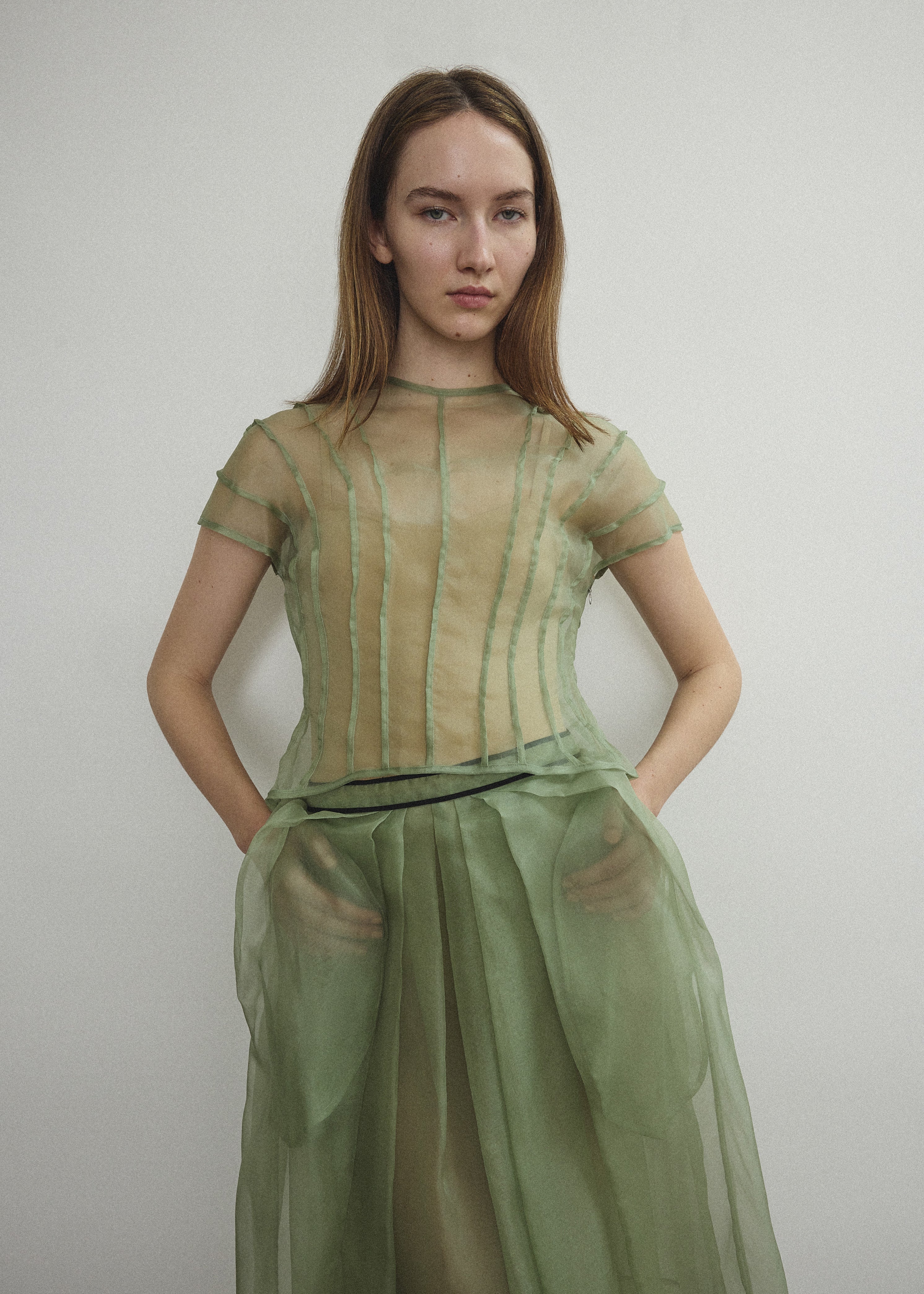 Model wearing the Jade silk organza Brise Skirt, showcasing its voluminous silhouette, sheer fabric, and elegant midi-length drape.