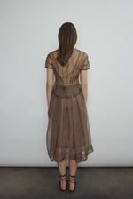 Model wearing the Mushroom silk organza Brise Skirt, showcasing its voluminous silhouette, sheer fabric, and elegant midi-length drape.