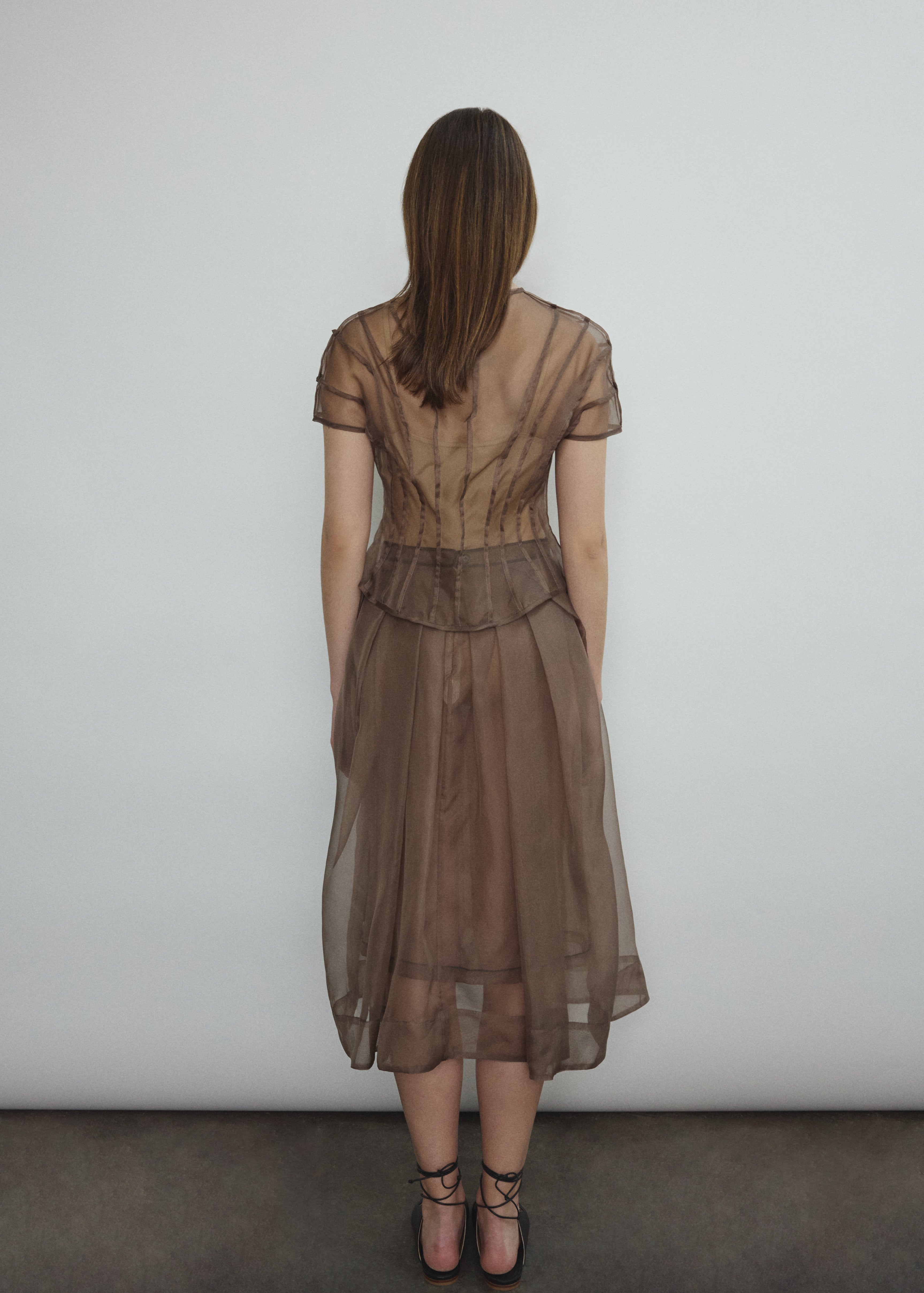 Model wearing the Mushroom silk organza Brise Skirt, showcasing its voluminous silhouette, sheer fabric, and elegant midi-length drape.