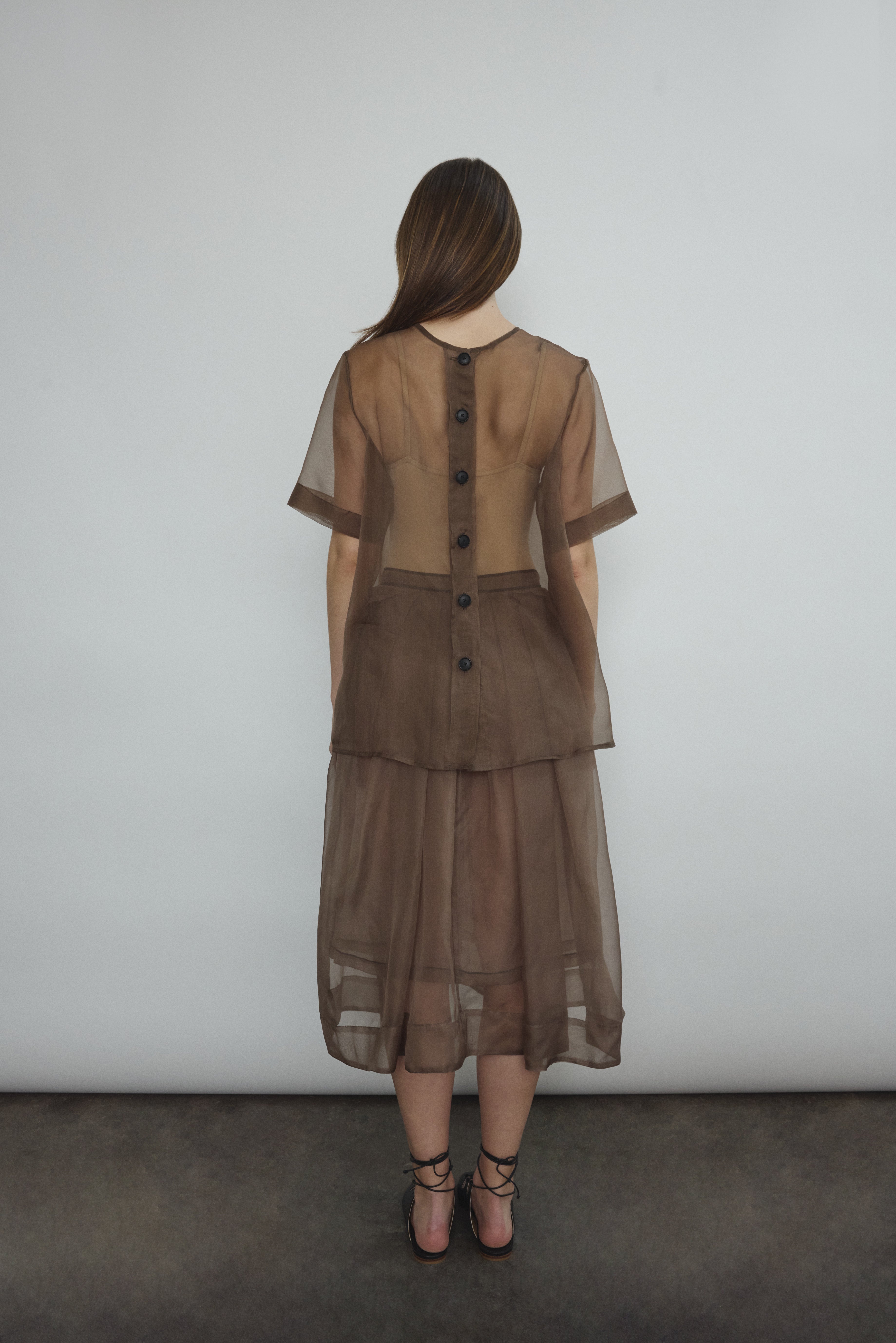 Model wearing the Mushroom silk organza Brise Skirt, showcasing its voluminous silhouette, sheer fabric, and elegant midi-length drape.